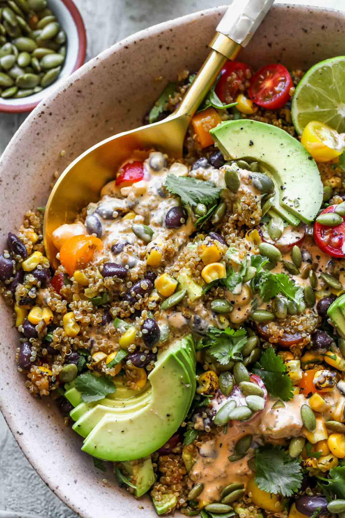 Serving spoon scooping out a serving of quinoa salad
