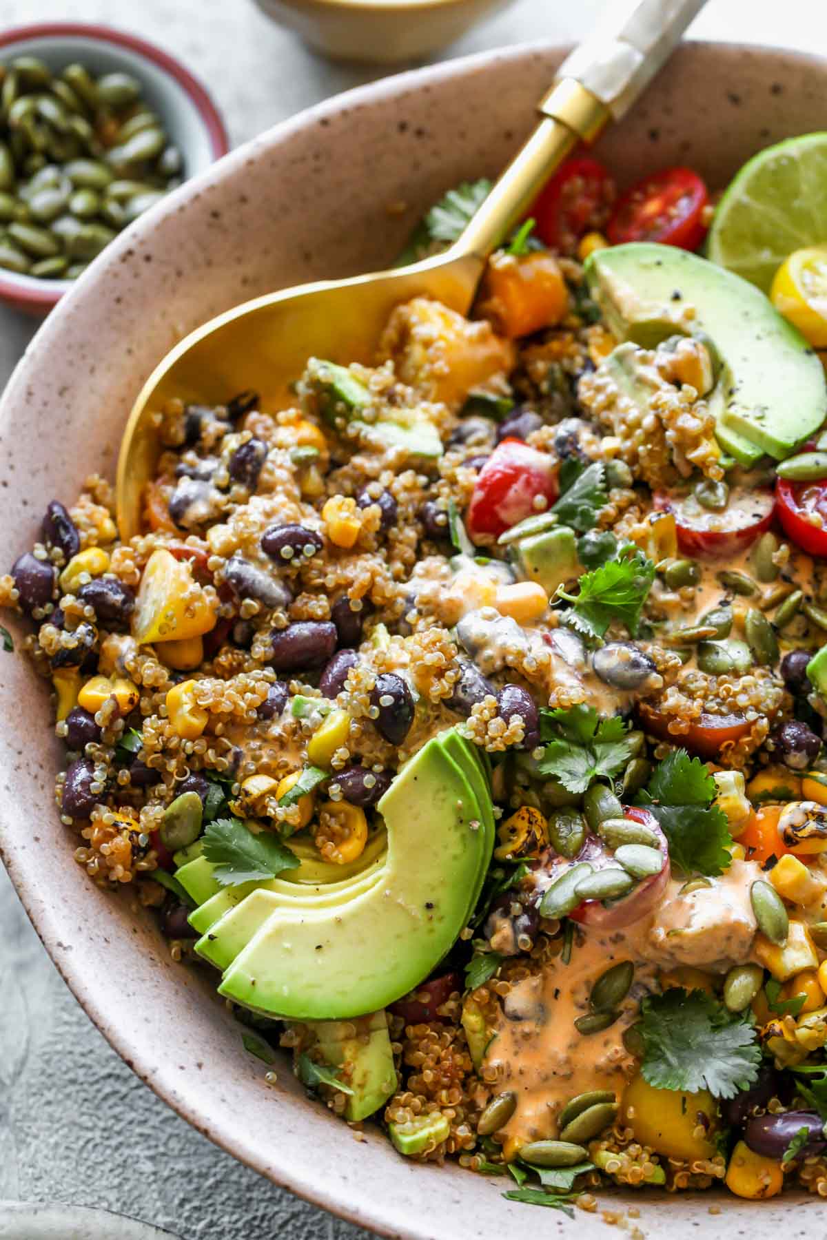 Southwest salad with quinoa and chipotle dressing styled in a large serving bowl