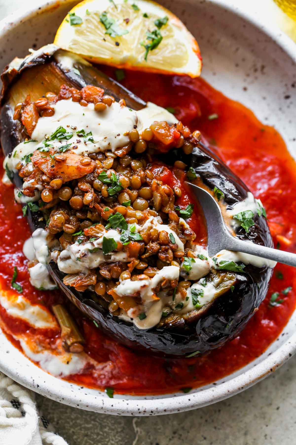 A bite being taken out of a stuffed eggplant