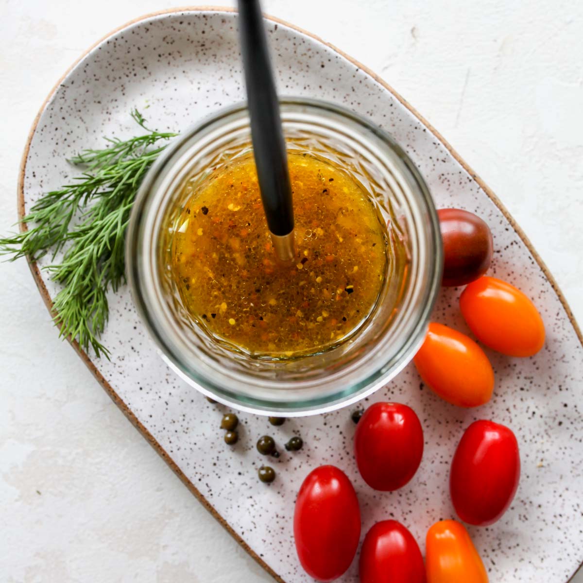 Dressing being mixed together in a glass jar