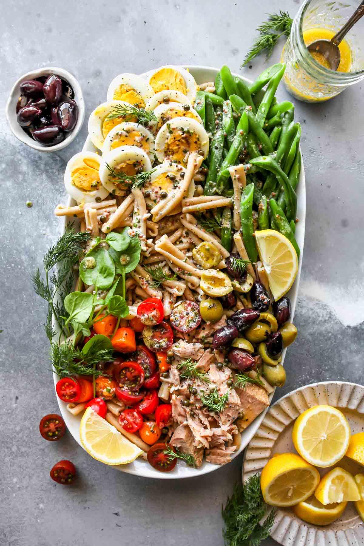 Assembled tuna noodle salad with dressing drizzled overtop