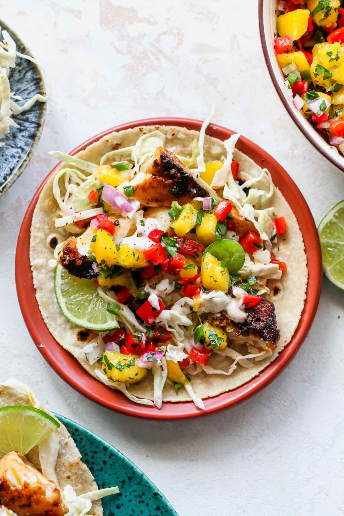 Baja fish taco being assembled on a plate