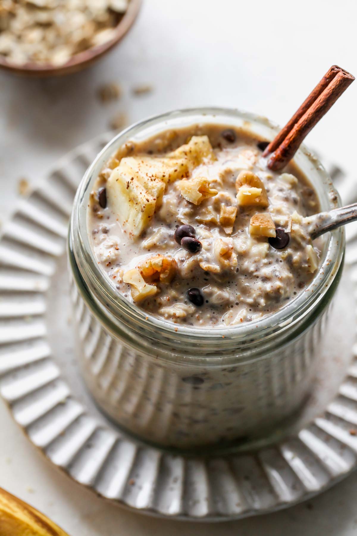 Spoon digging into a jar of overnight oats taking out a bite