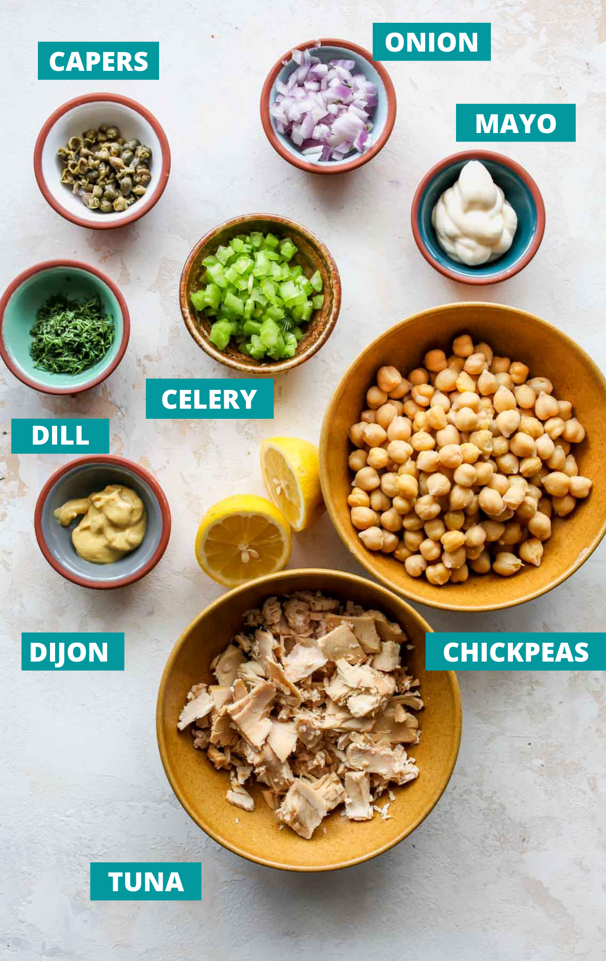 Recipe ingredients in separate bowls on a white board with green labels.