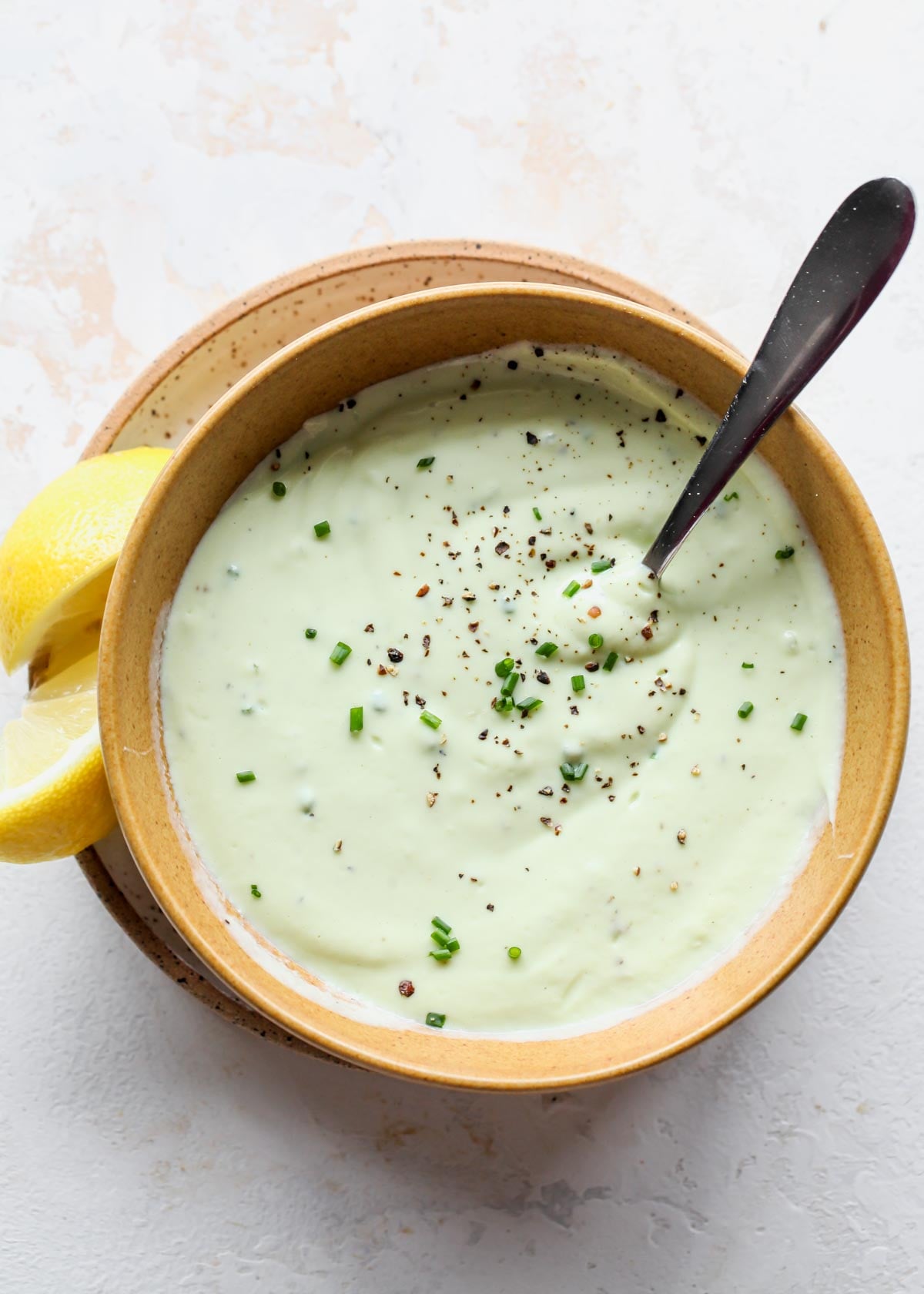 Avocado ranch dressing in a gold bowl