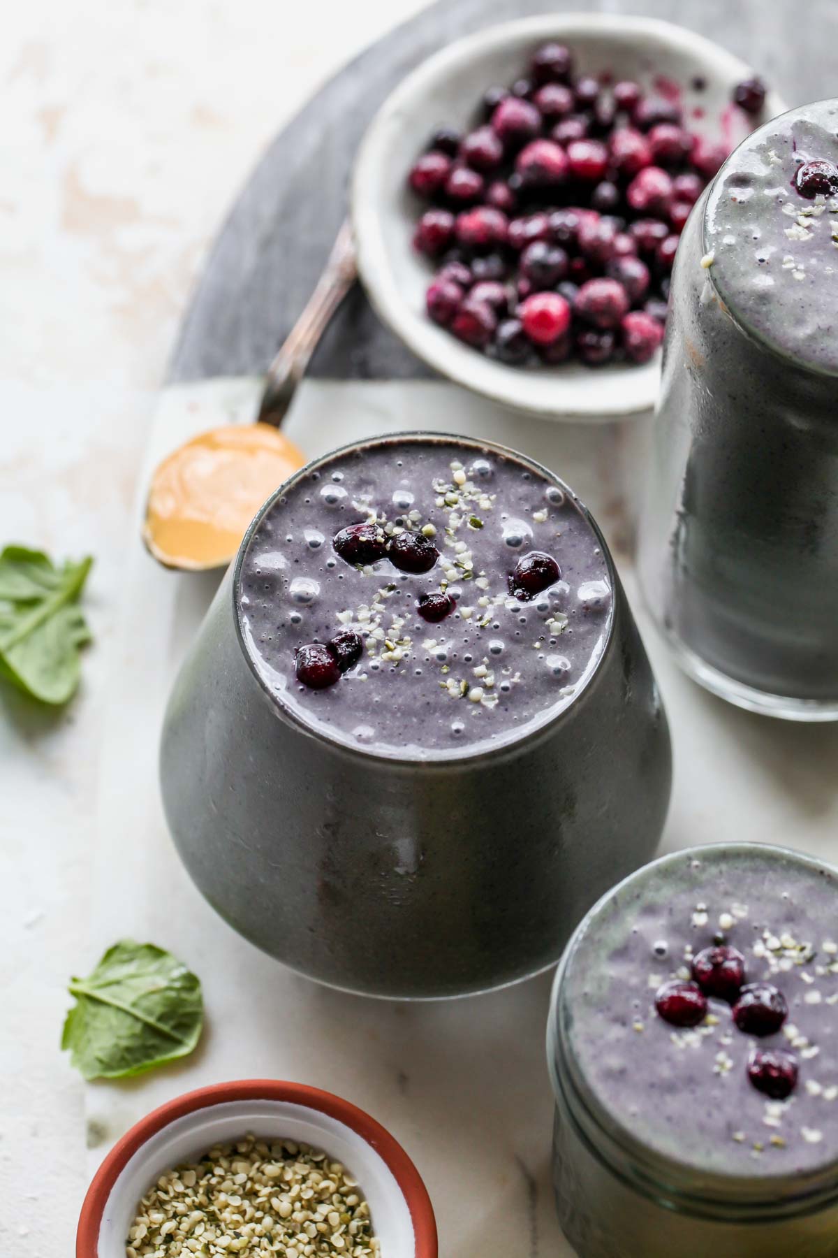 Blueberry banana smoothie in a glass topped with fresh blueberries