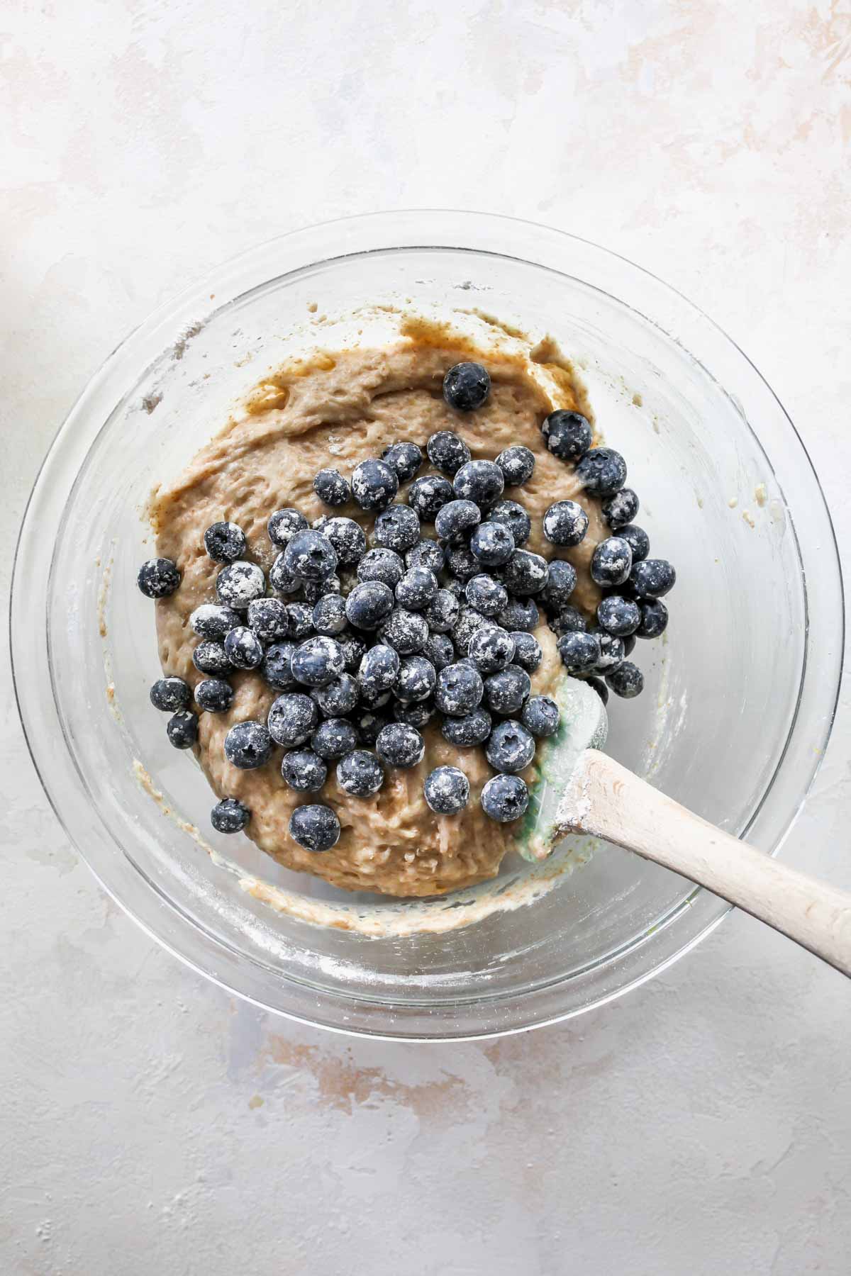 Blueberries being folded into muffin batter