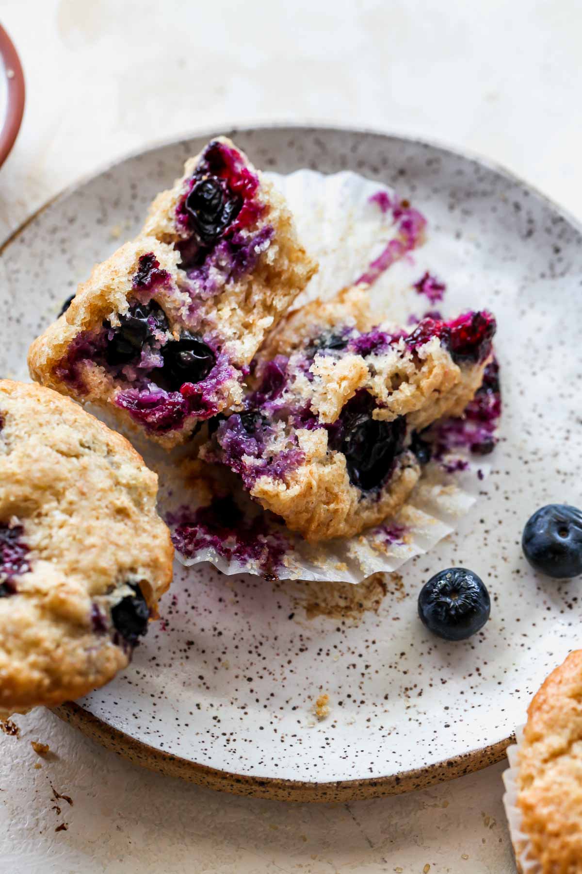 A muffin being sliced in half on a plate
