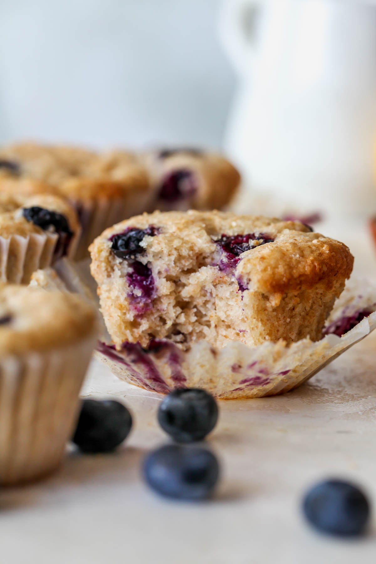 A bite taken out of a blueberry muffin to show the inside