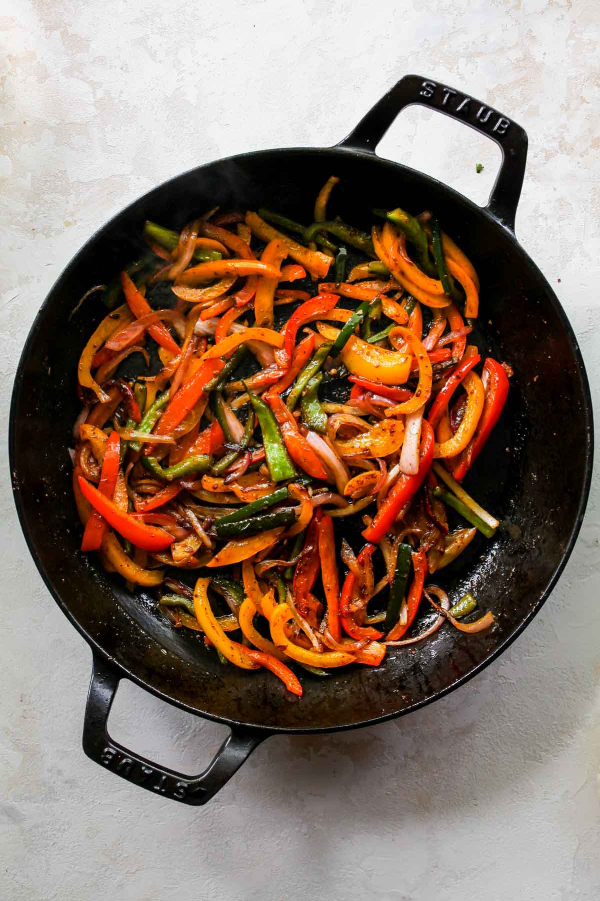 Fajita veggies in a black cast iron skillet