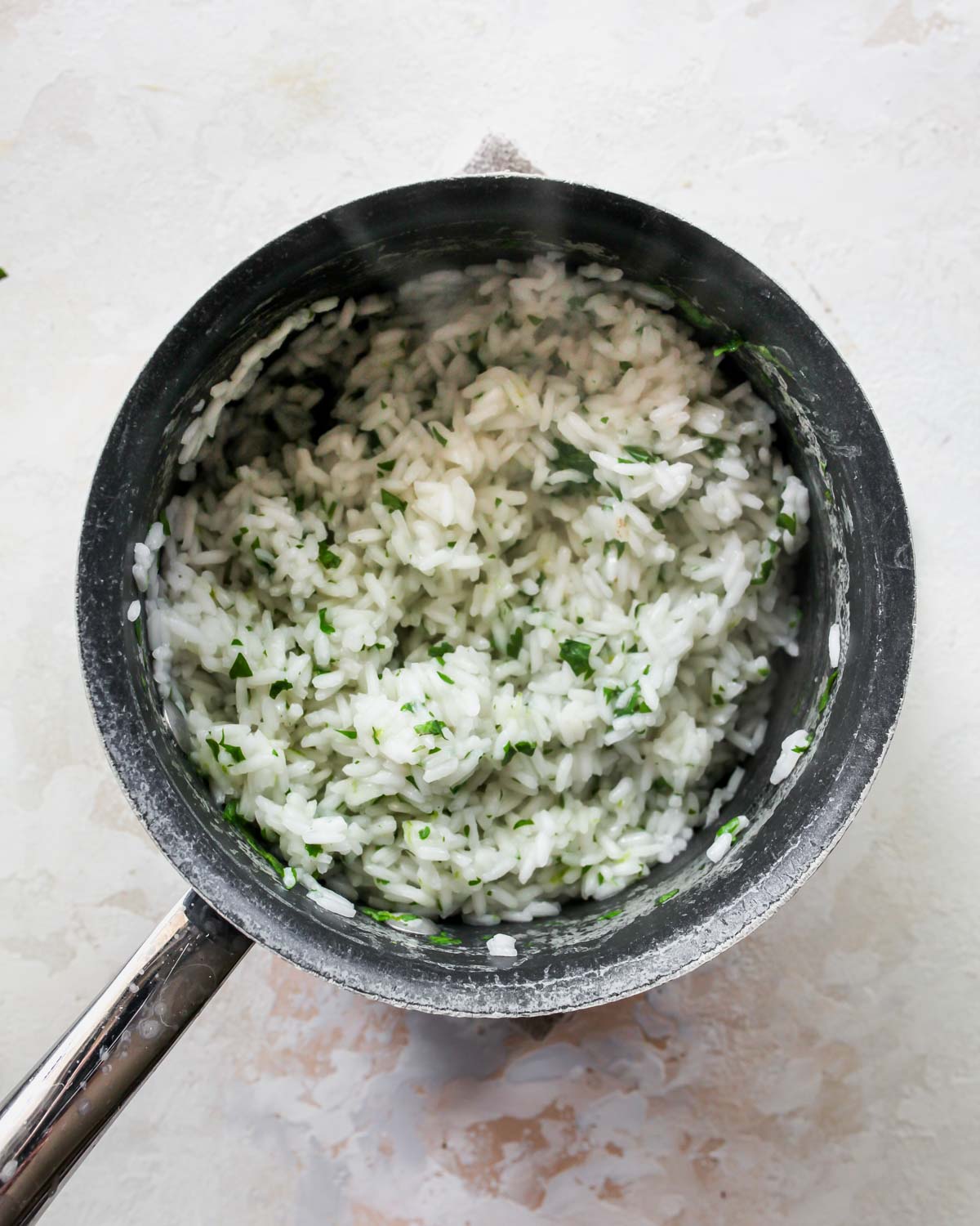 Cilantro-lime rice cooked in a small saucepan