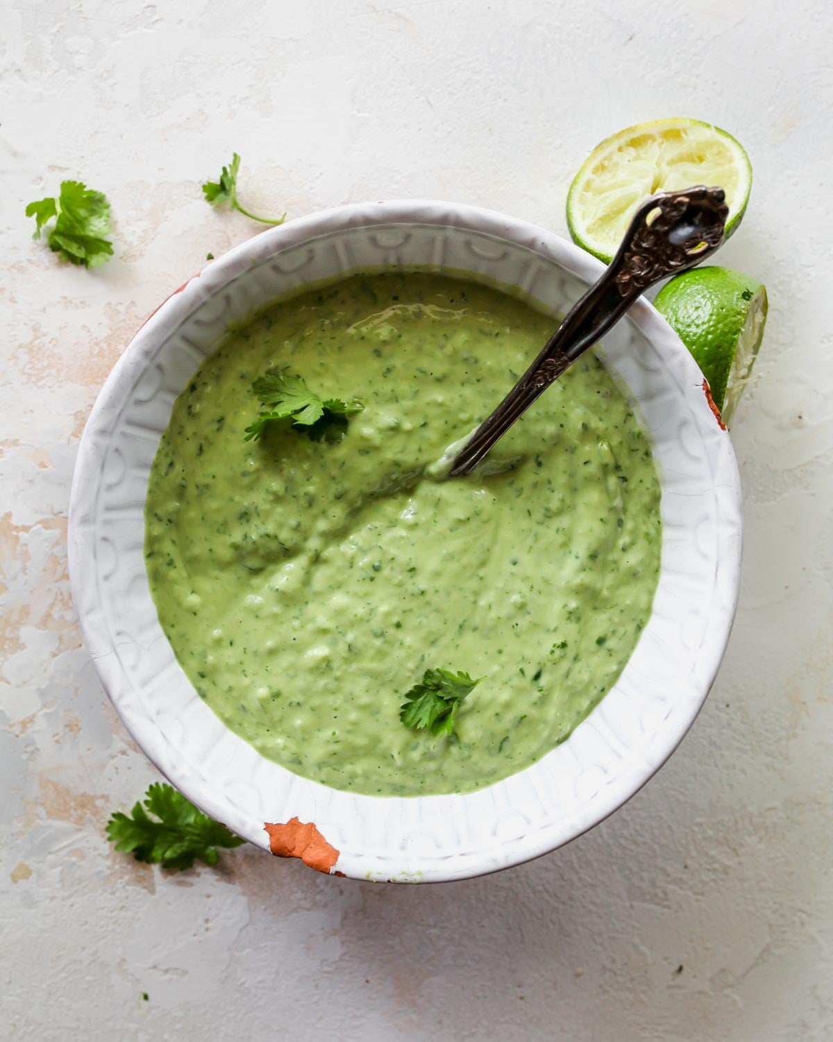 Blended avocado cream sauce in a white bowl