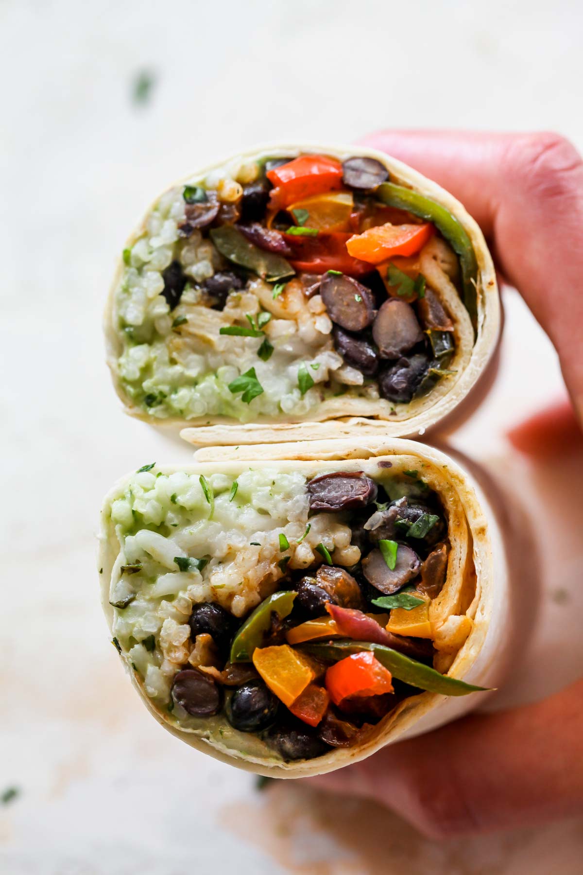 Vegetarian burrito sliced in half to see the fillings