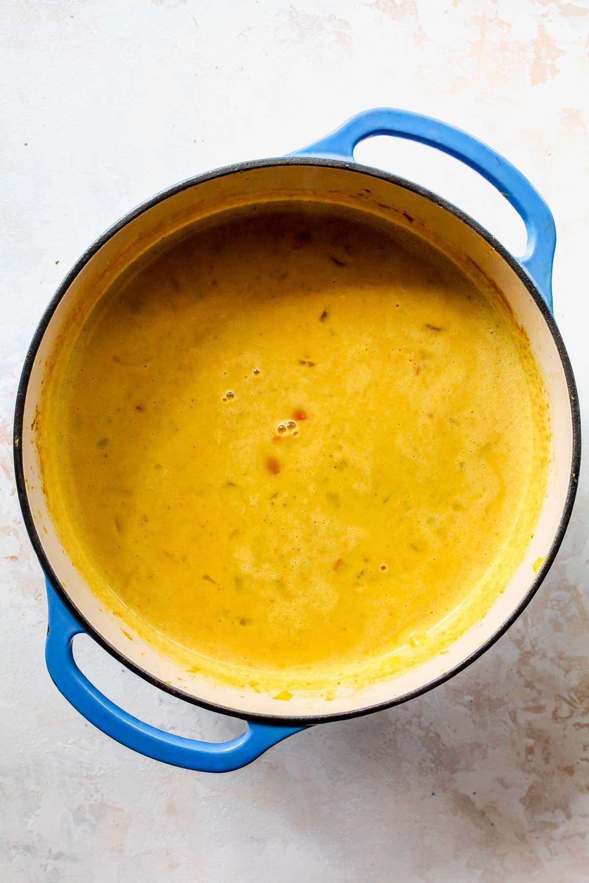 Finished chowder in a blue pot with lime juice stirred in