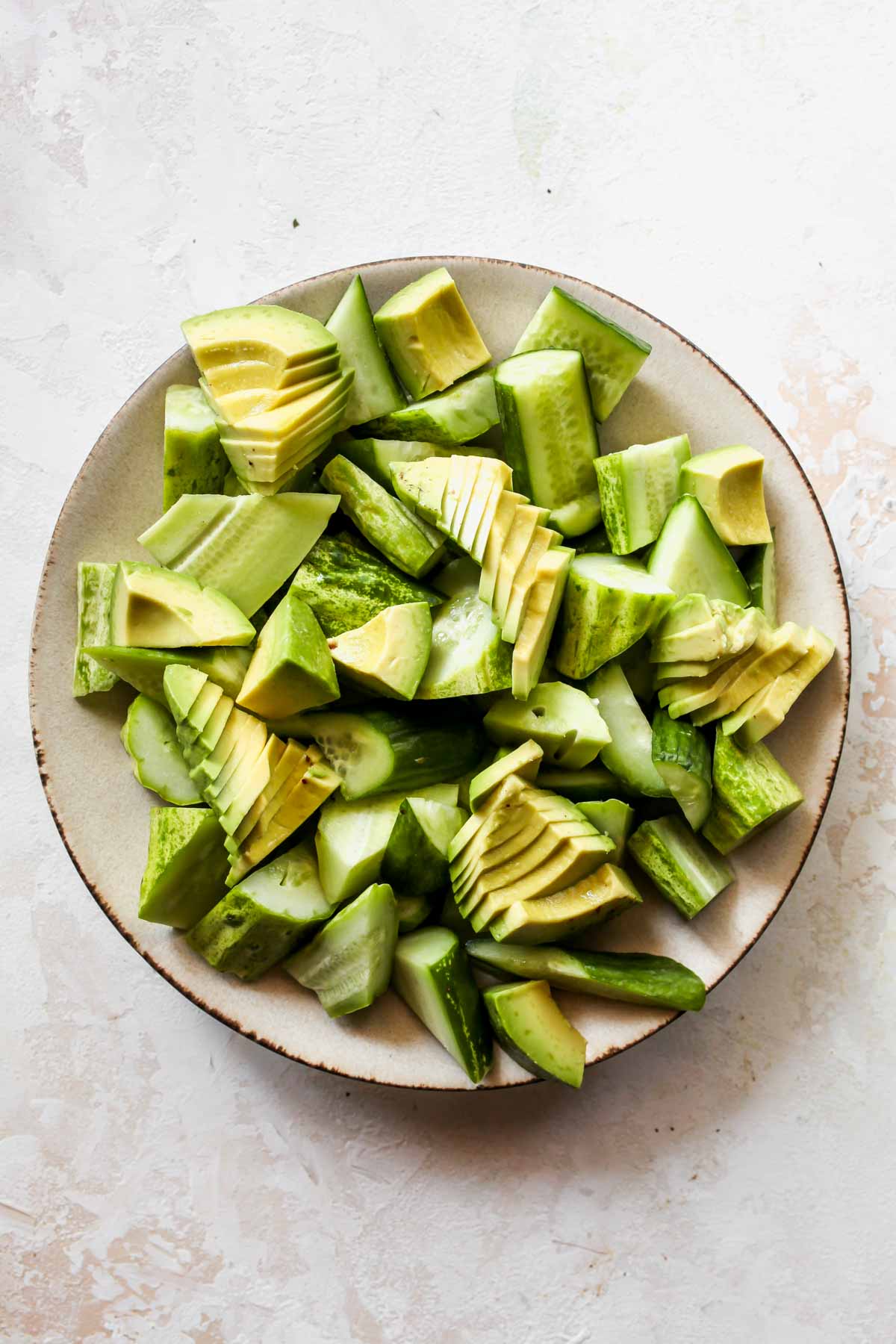 Cucumber and avocado slices arranged on a platter