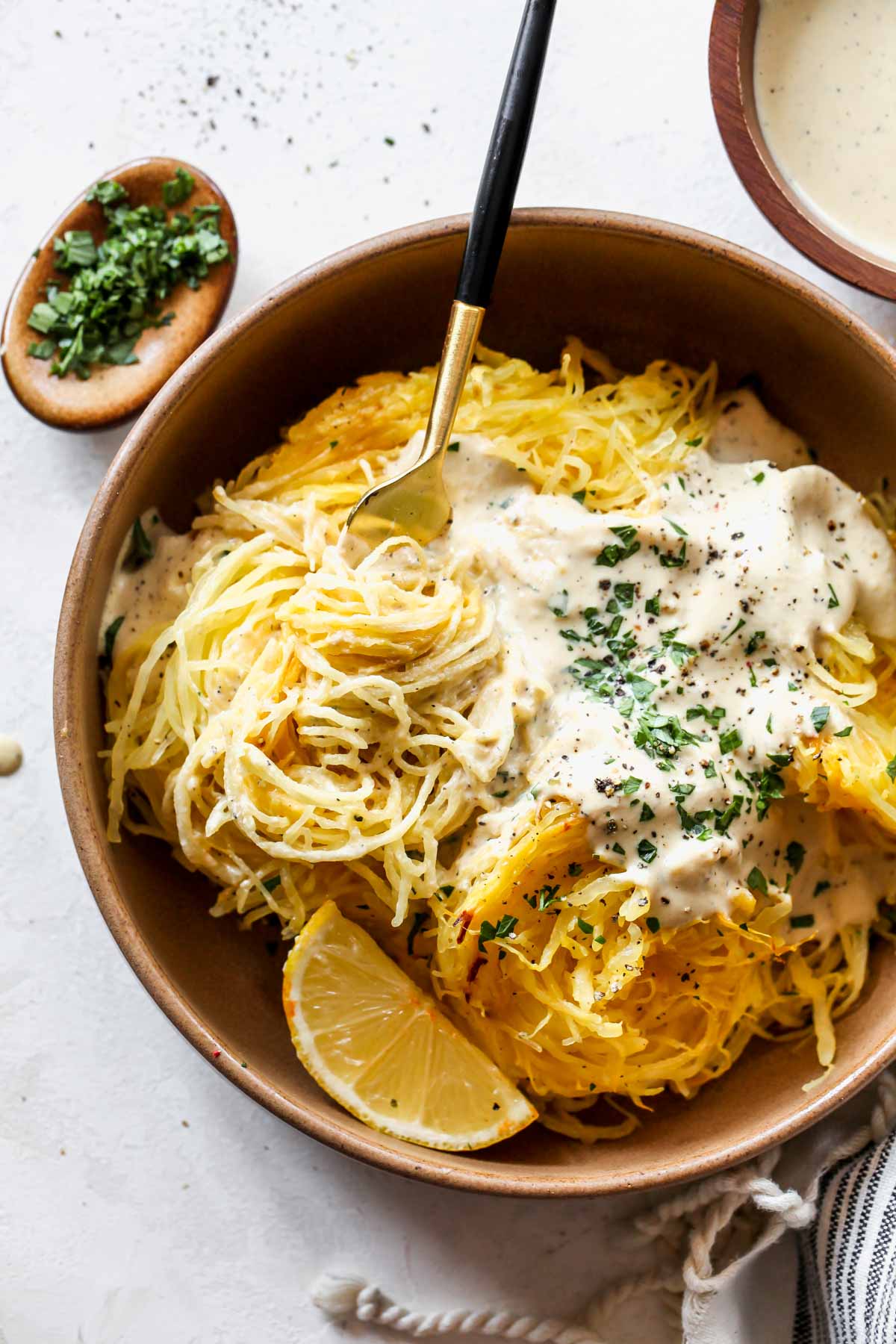 A fork taking out a bite of vegan Alfredo