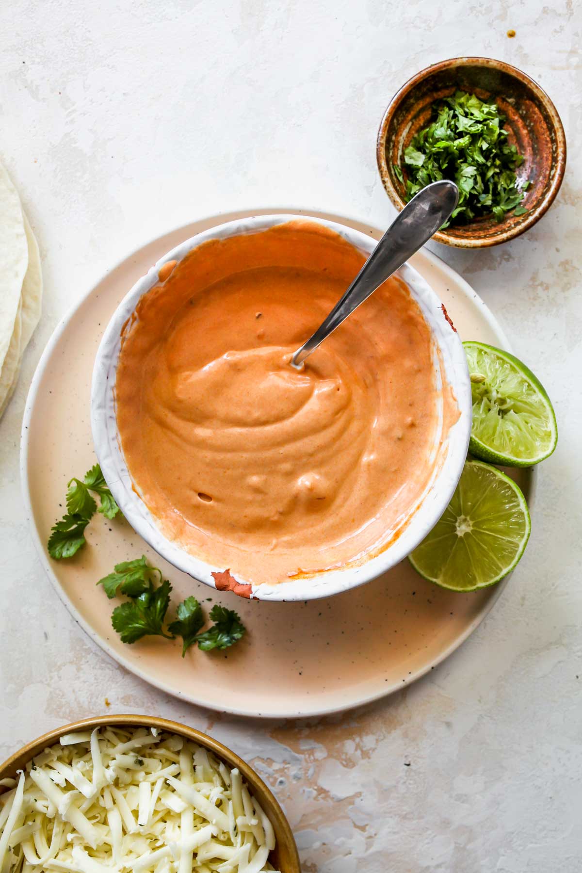 Chipotle-mango yogurt sauce being mixed in a bowl