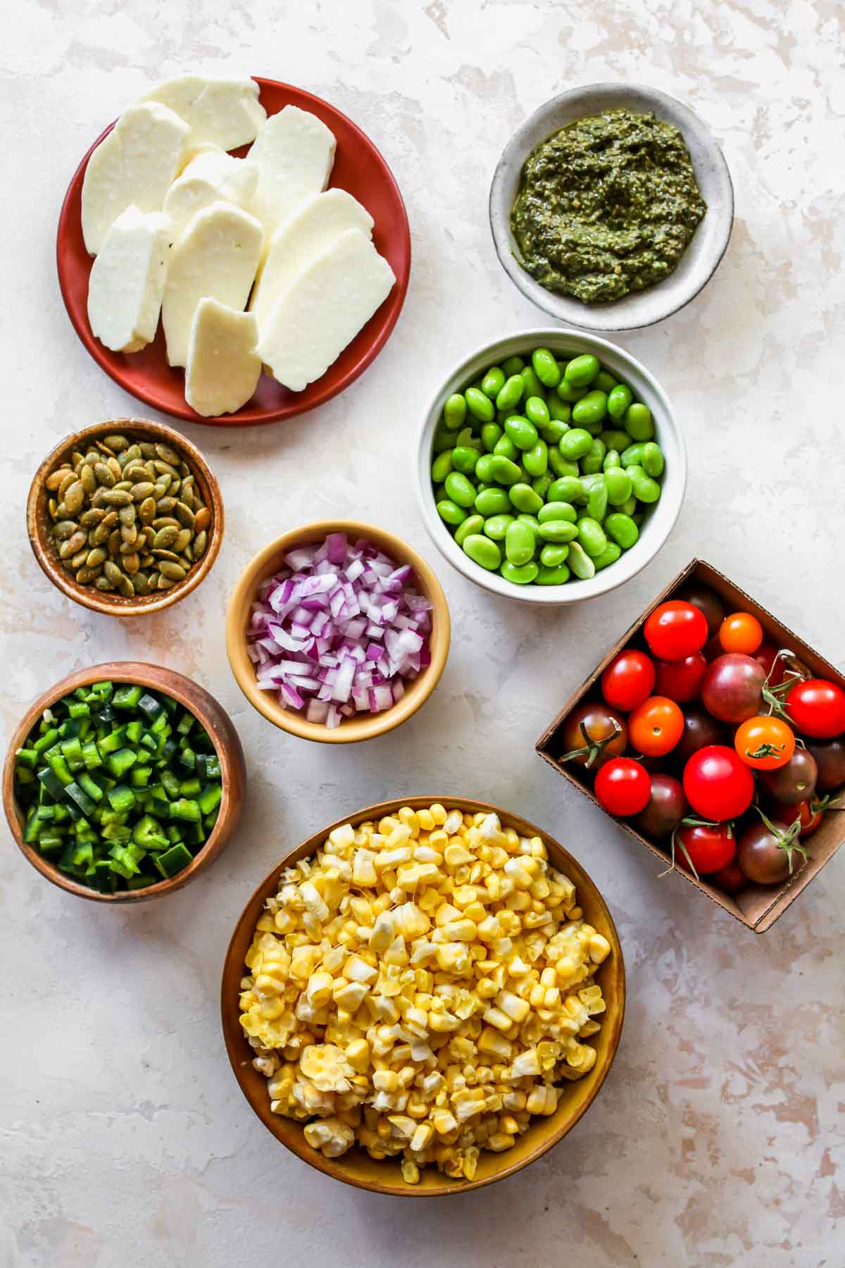 Recipe ingredients in separate bowls on a white board