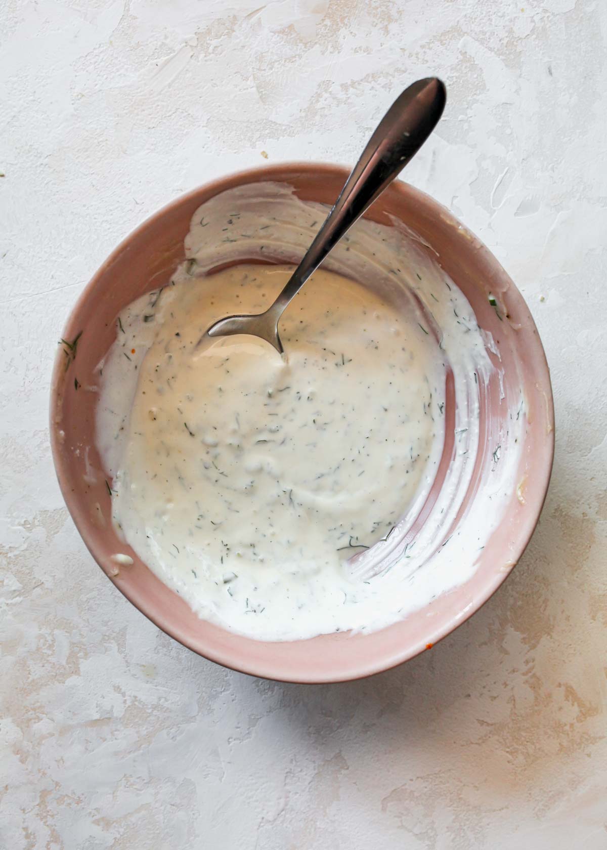 Lemon-Dill Sauce being mixed in a pink bowl