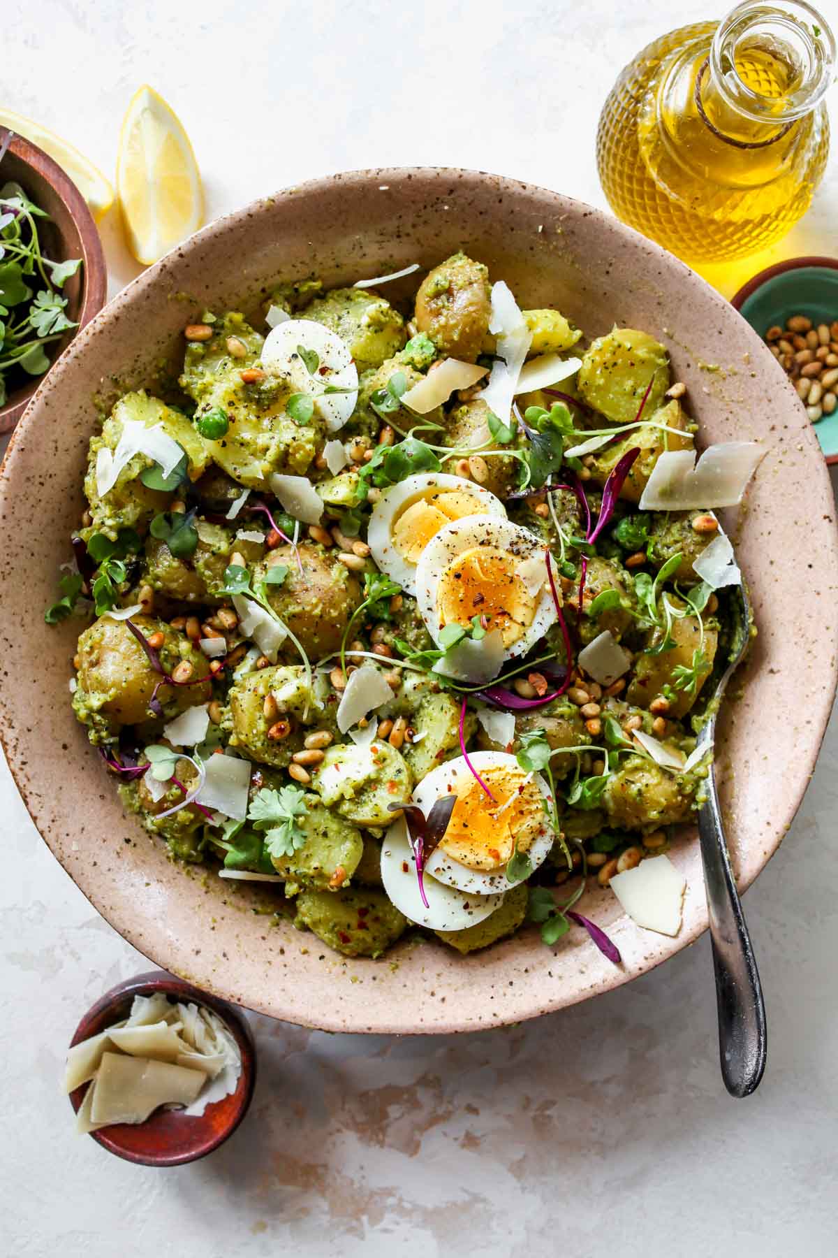 Pesto potato salad styled in a pink bowl