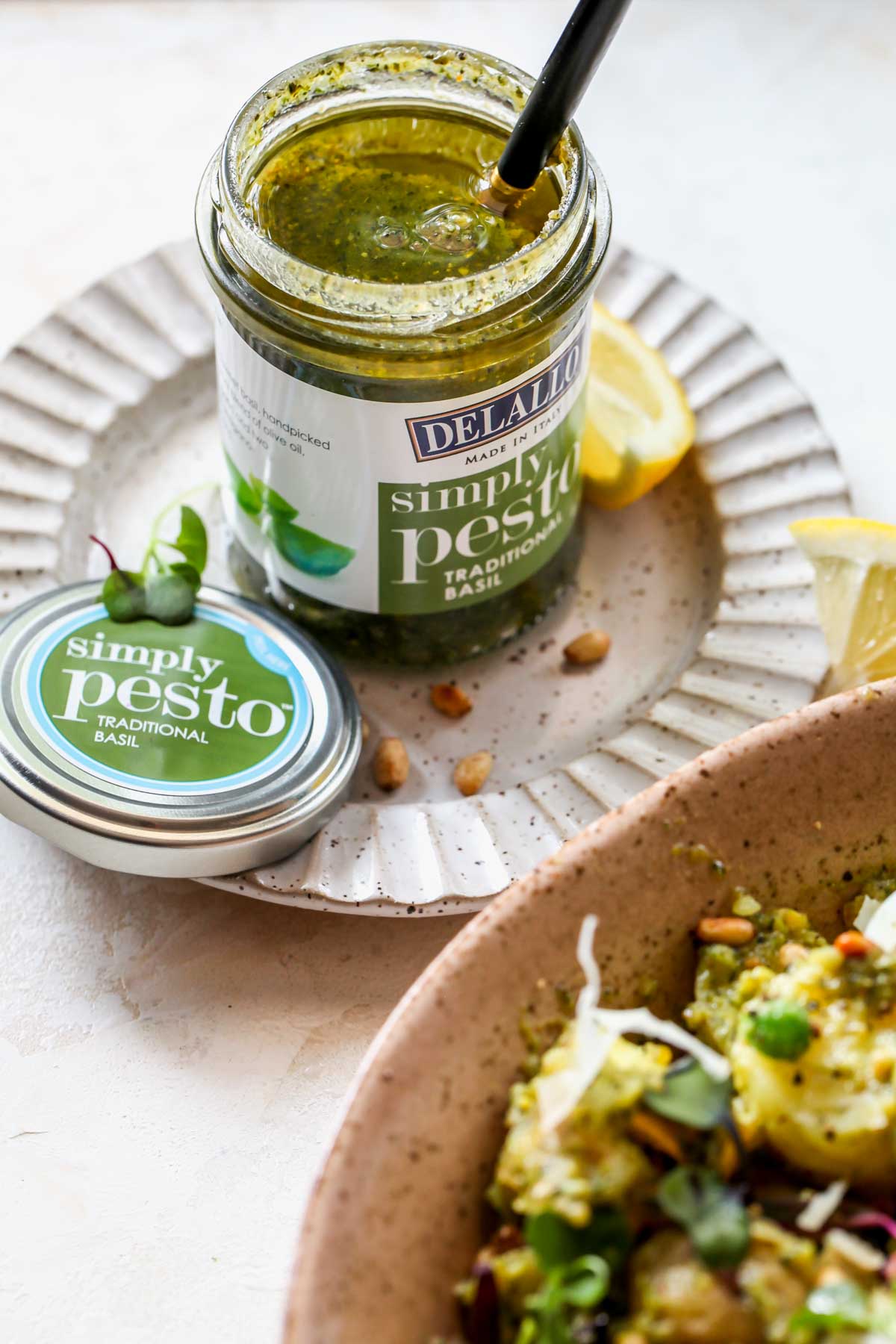 Jar of DeLallo pesto sitting on a plate