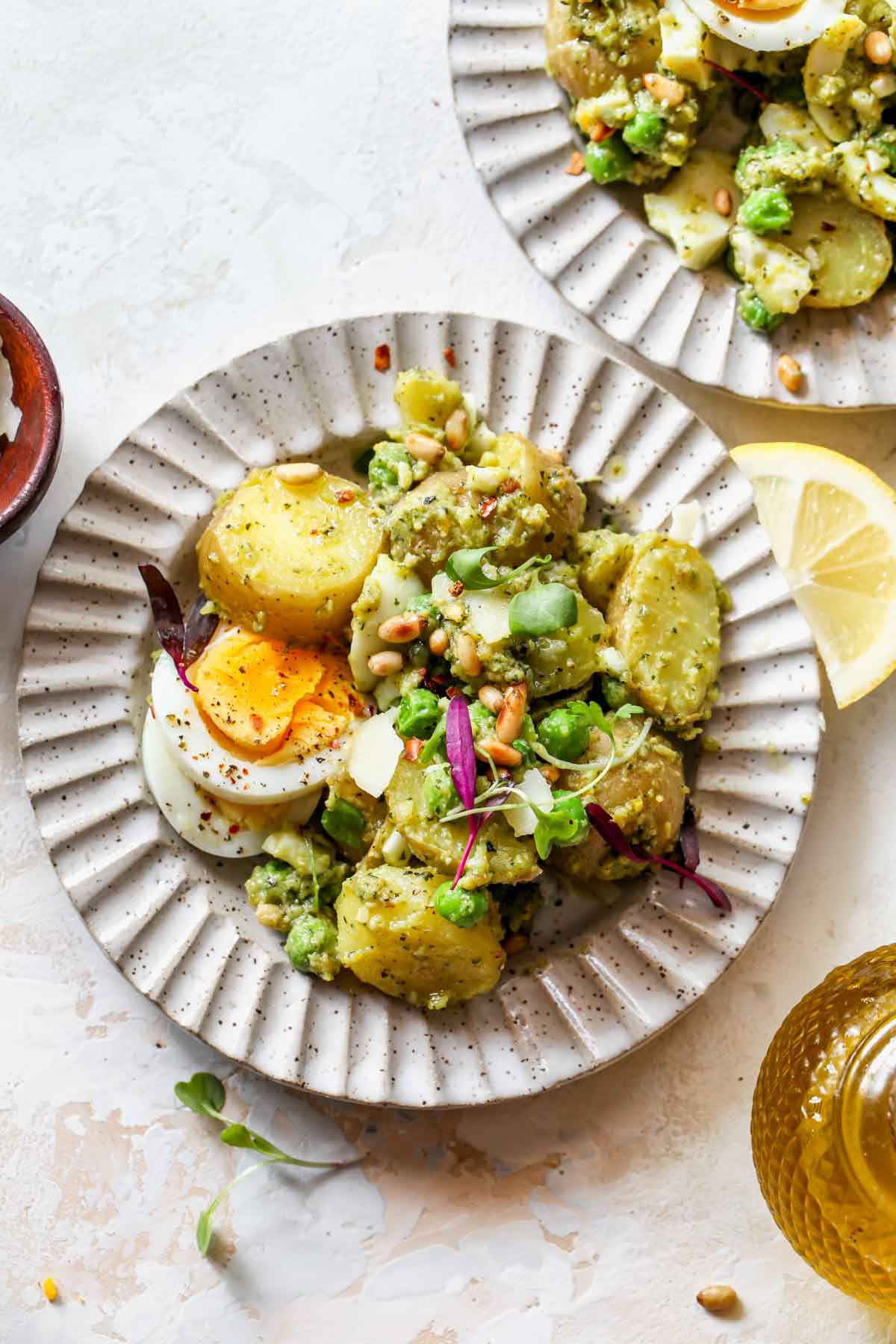 A portion of potato salad served on a small white plate