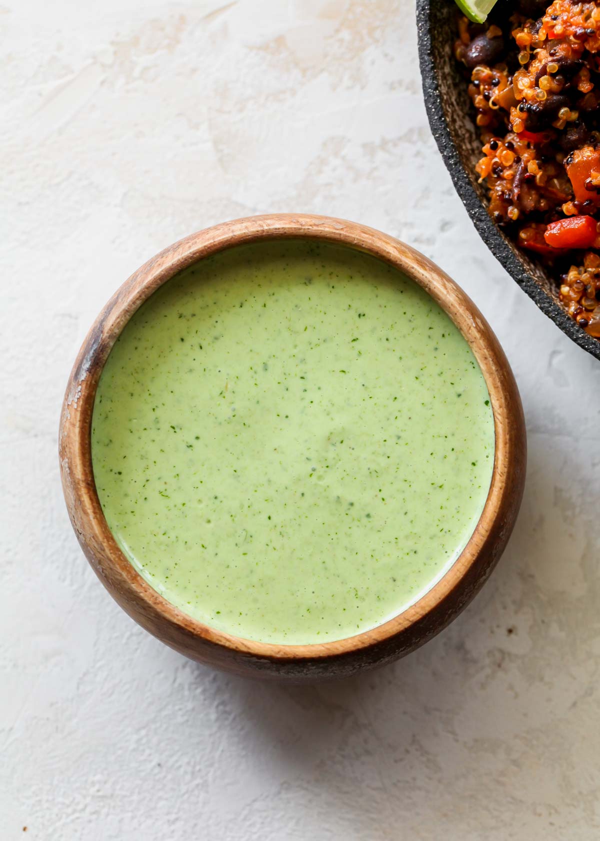 Cilantro-lime sauce in a small brown bowl