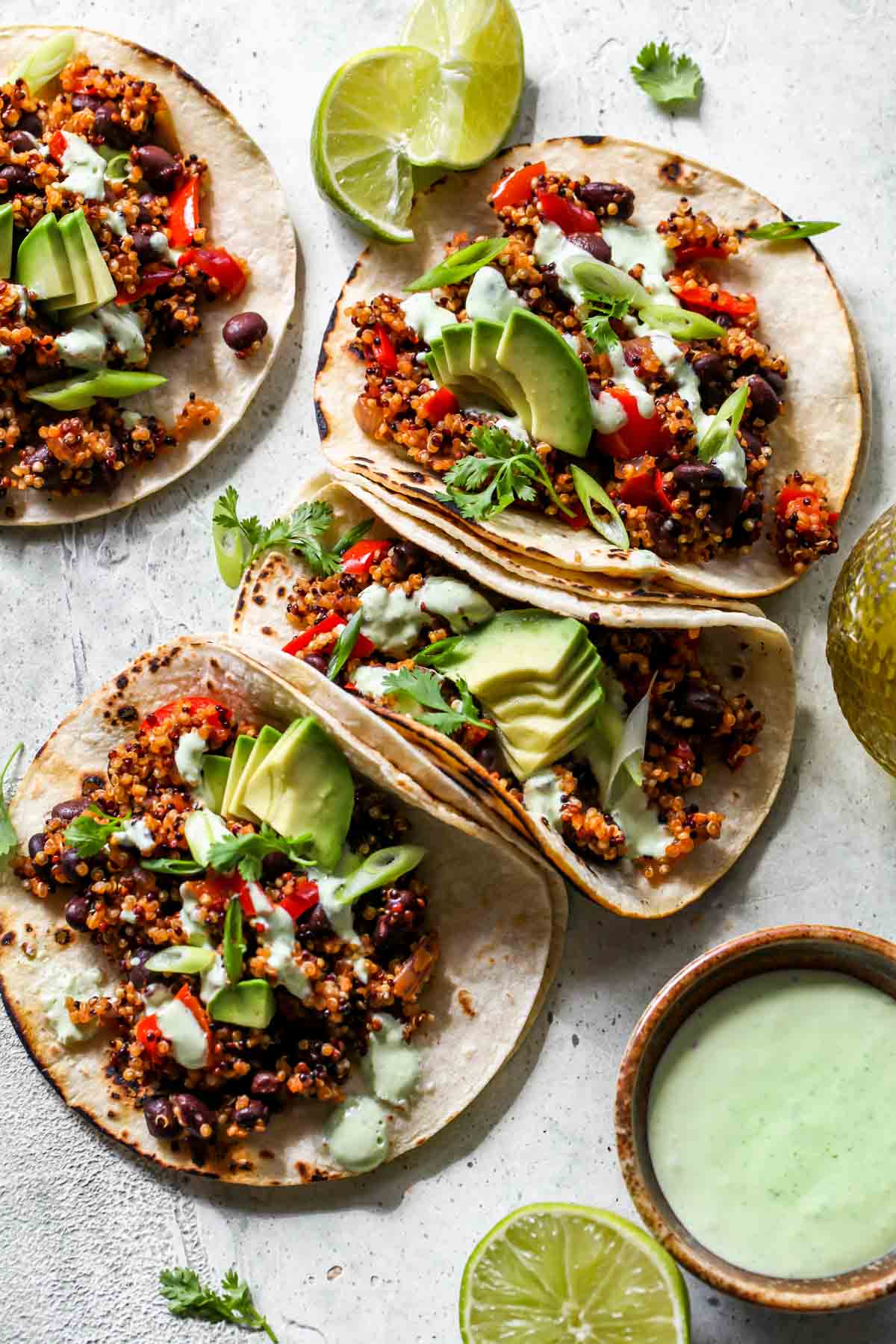 Quinoa tacos lined up in a row on a white board