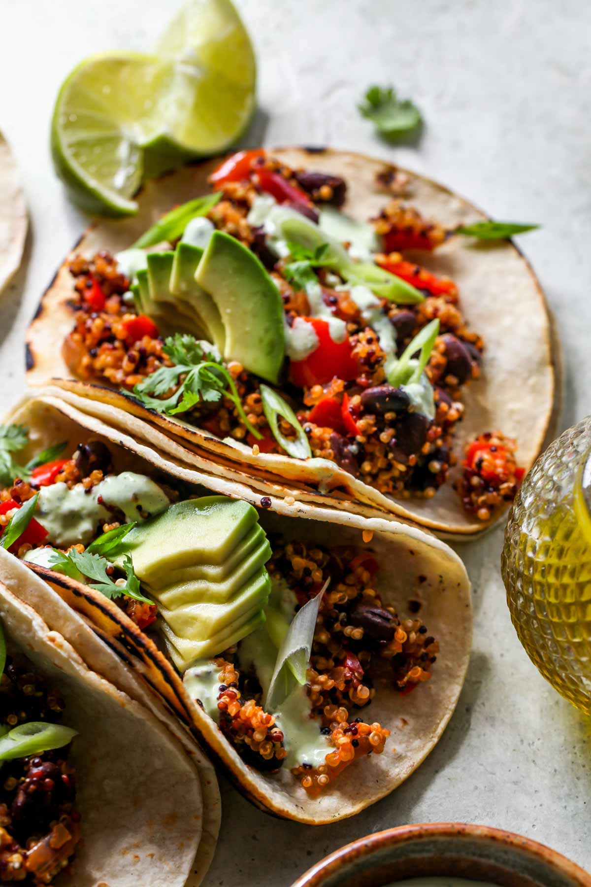 Two tacos assembled next to each other on a grey board