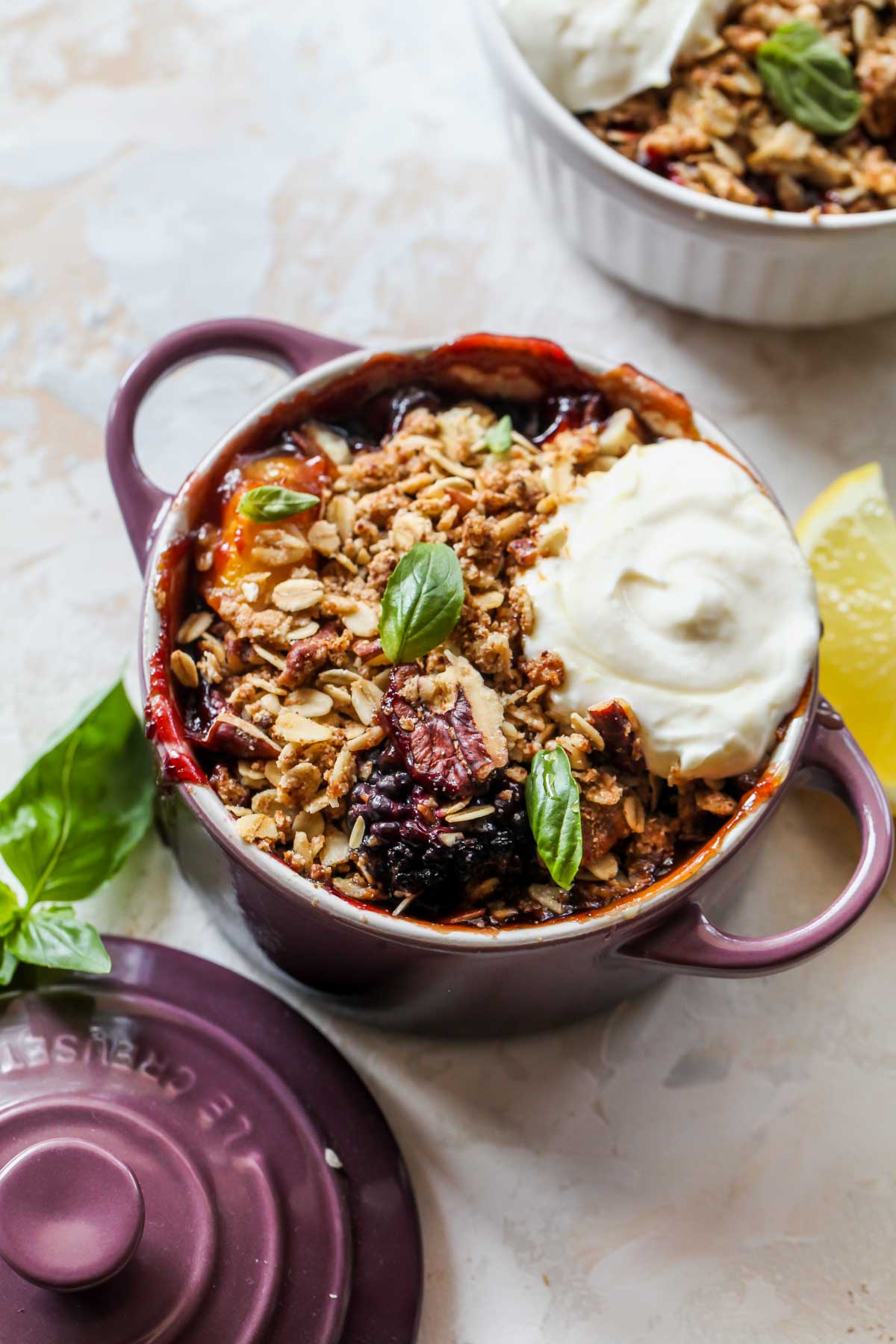 Peach fruit crisp topped with a dollop of yogurt