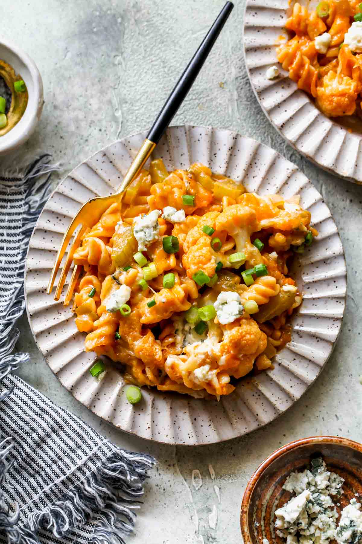 One serving of buffalo mac and cheese on a small gray plate