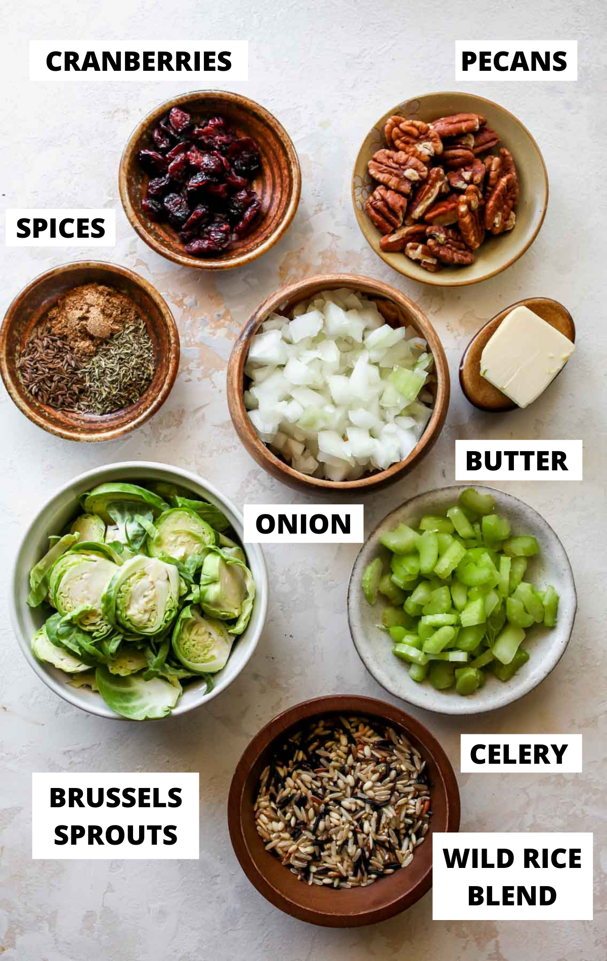 Pilaf ingredients in separate bowls on a white board with labels.