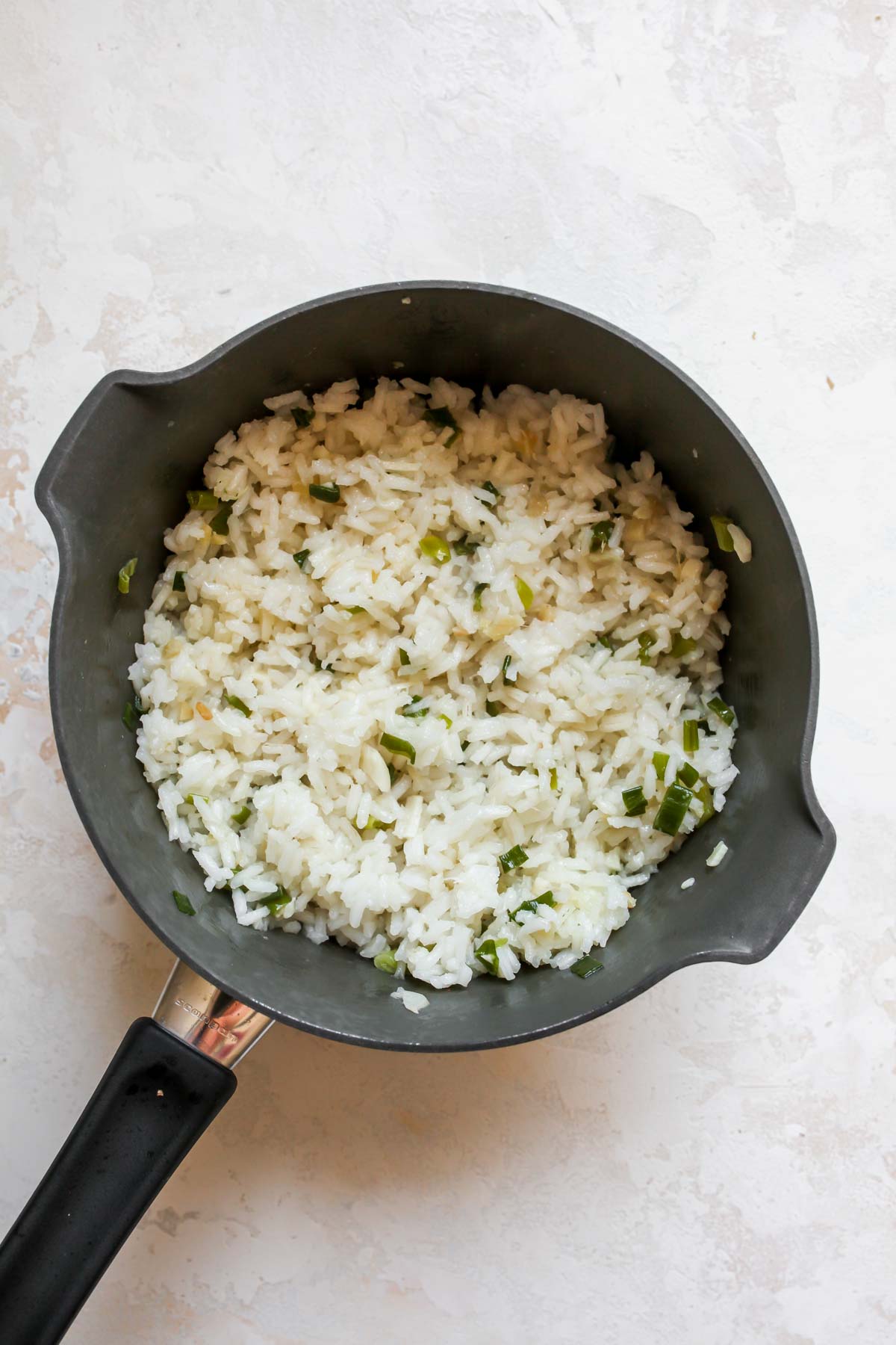 Ginger-scallion rice in a saucepan