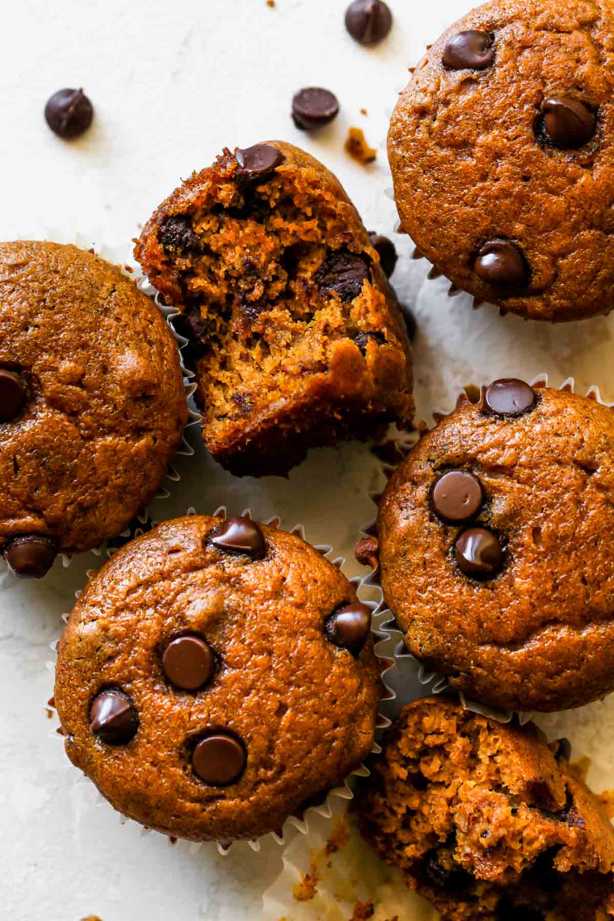 Pumpkin chocolate chip muffins on a white board