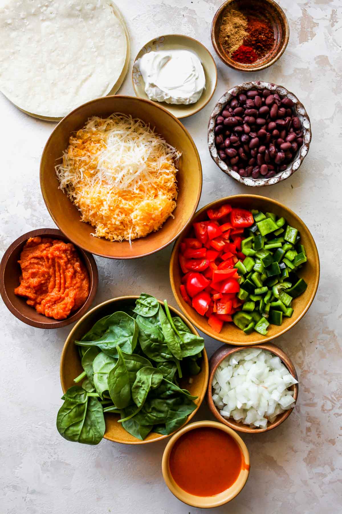 Recipe ingredients in separate bowls on a white board