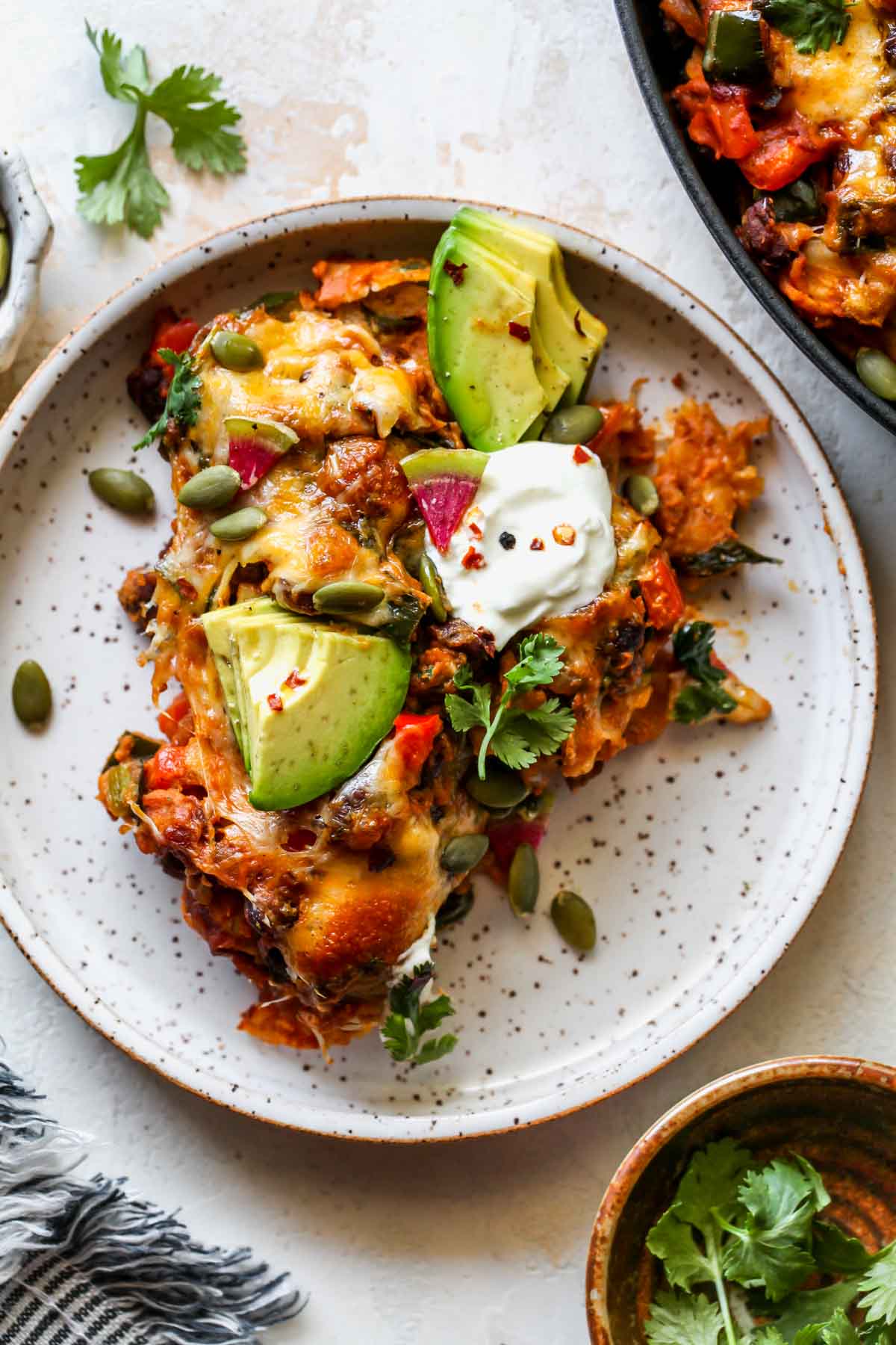 A scoop of enchiladas styled on a white plate