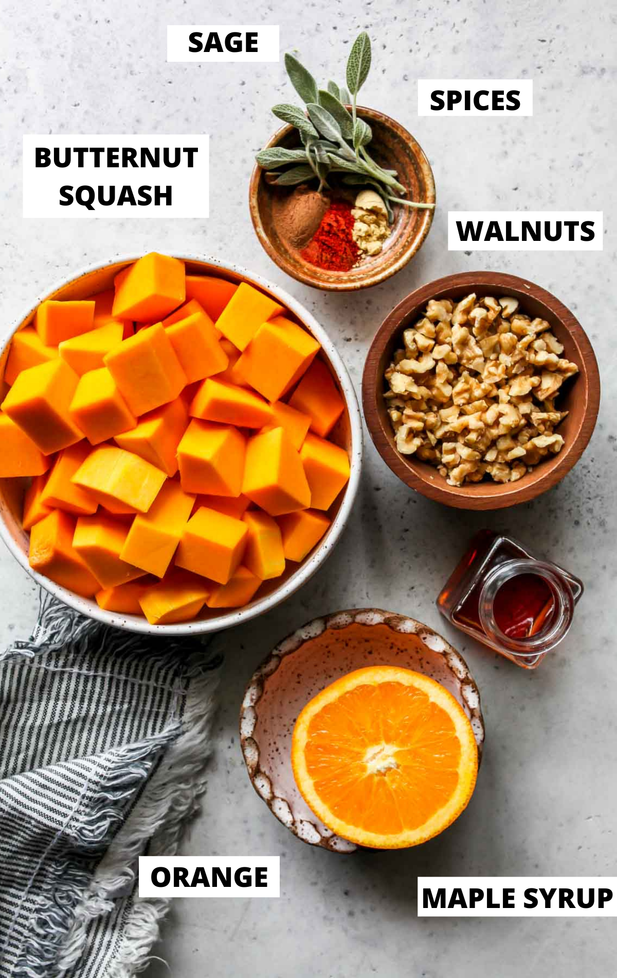 Recipe ingredients in separate bowls on a gray board with labels