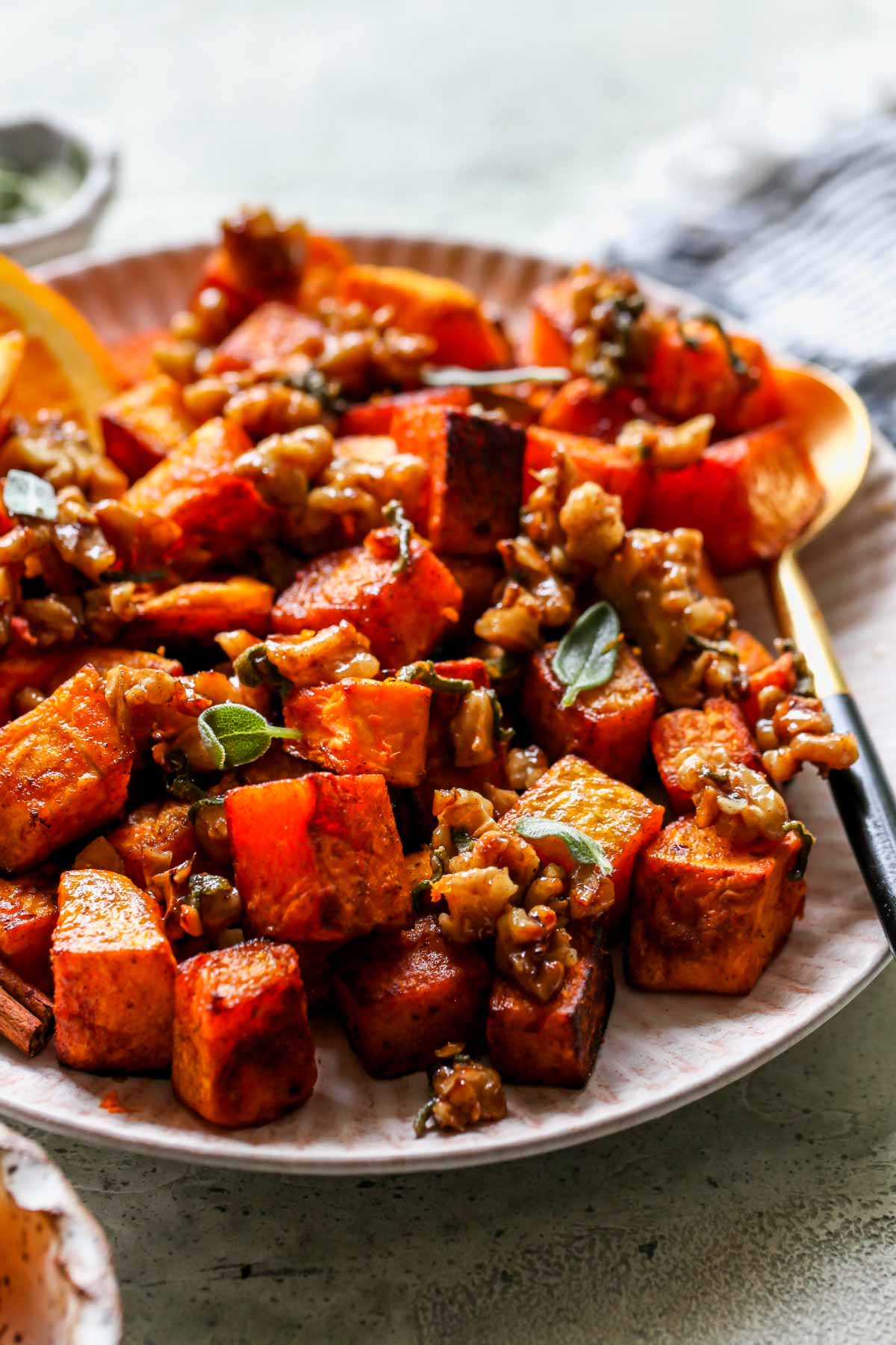 Side view of roasted squash topped with candied walnuts