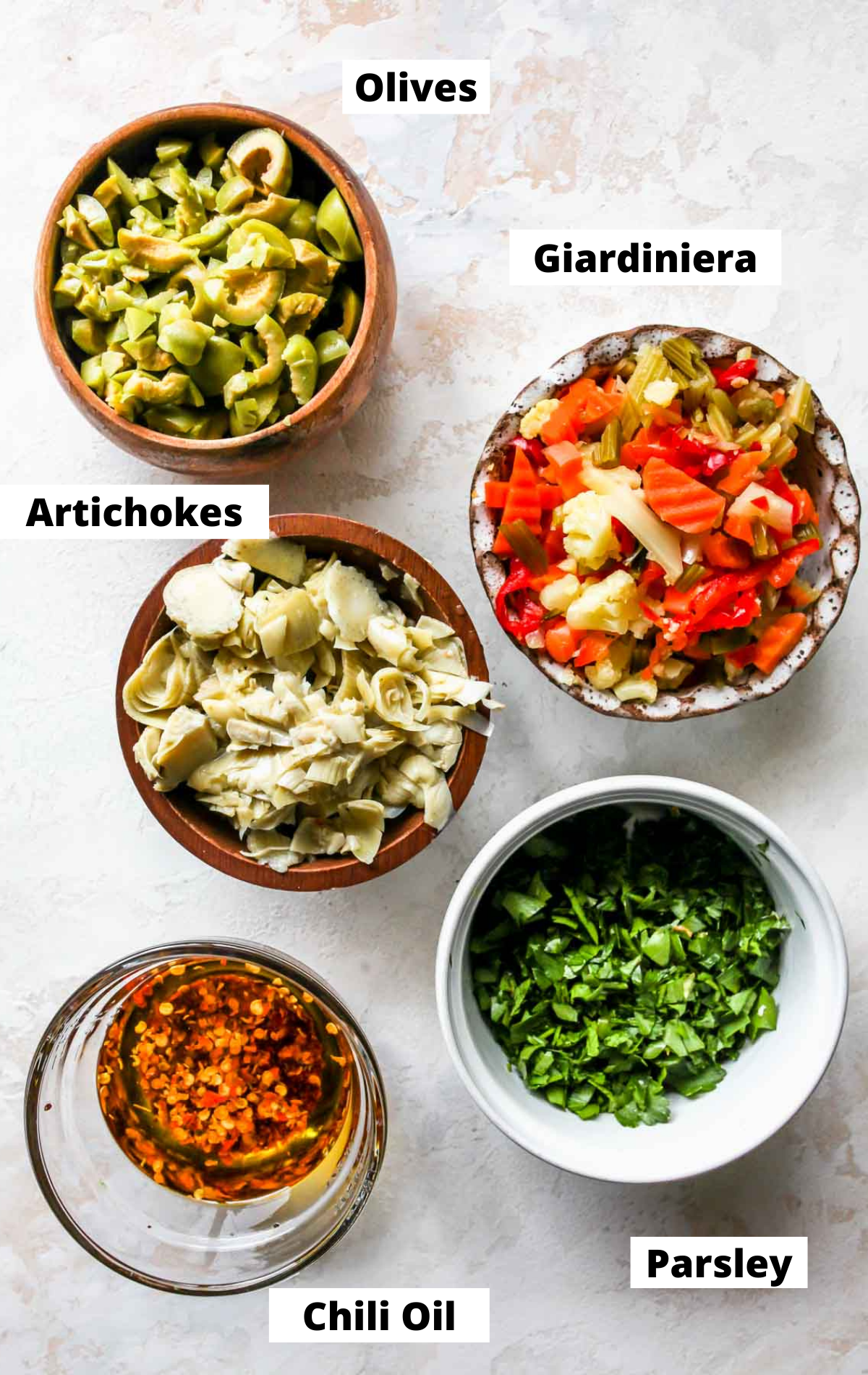 Recipe ingredients in separate bowls on white board with labels