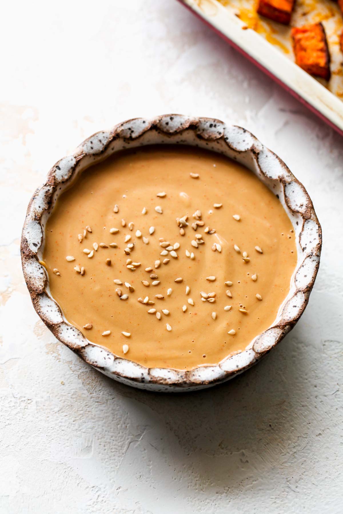 Almond butter dressing being mixed in a bowl