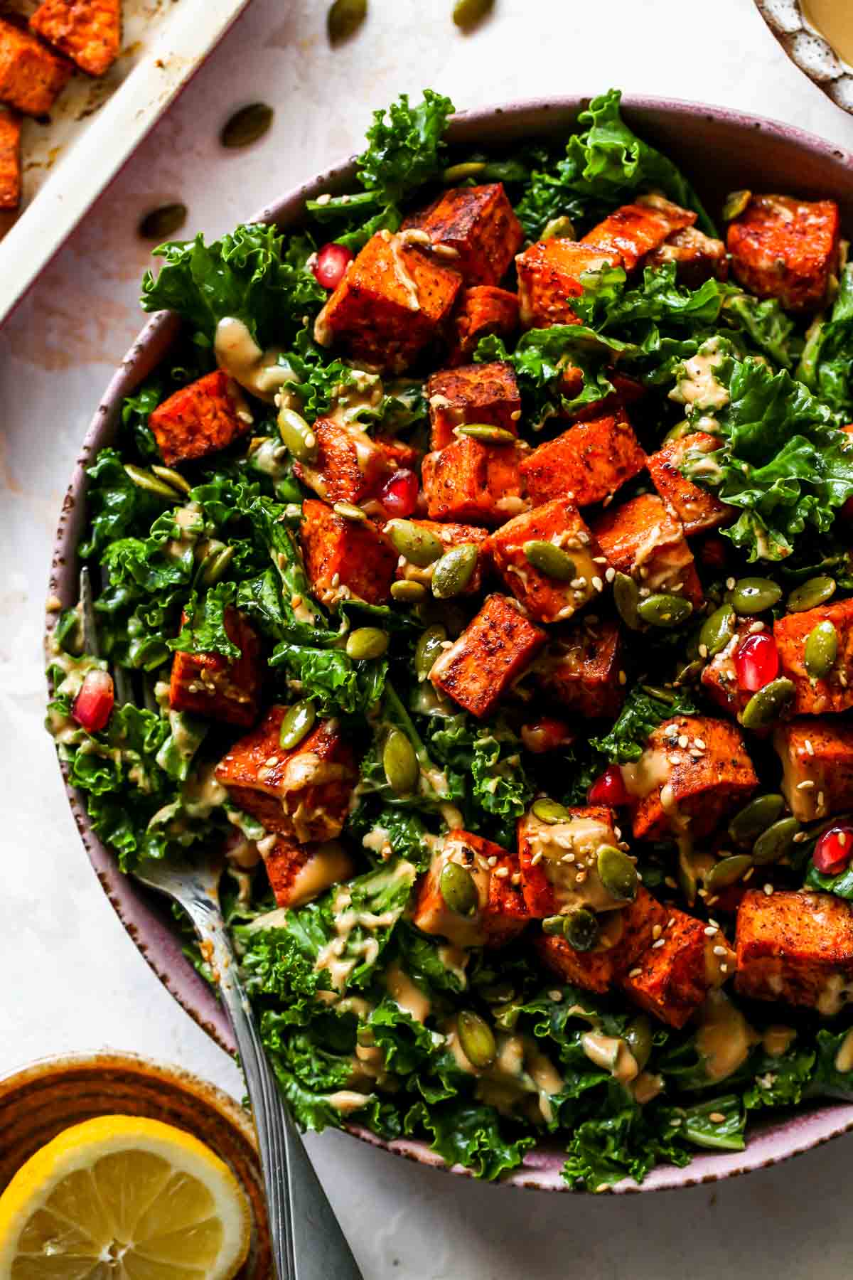 A fork taking out a bite of kale salad