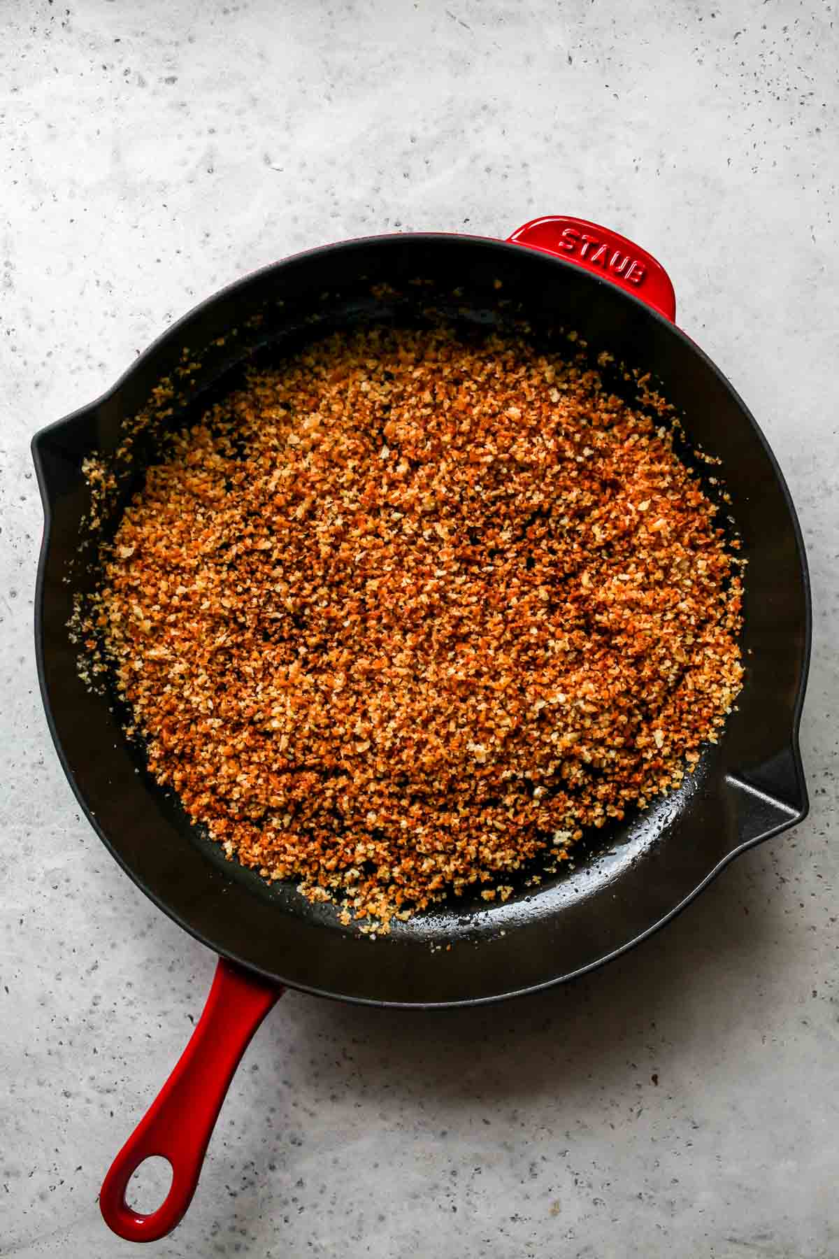 Panko breadcrumbs being toasted until golden in a skillet