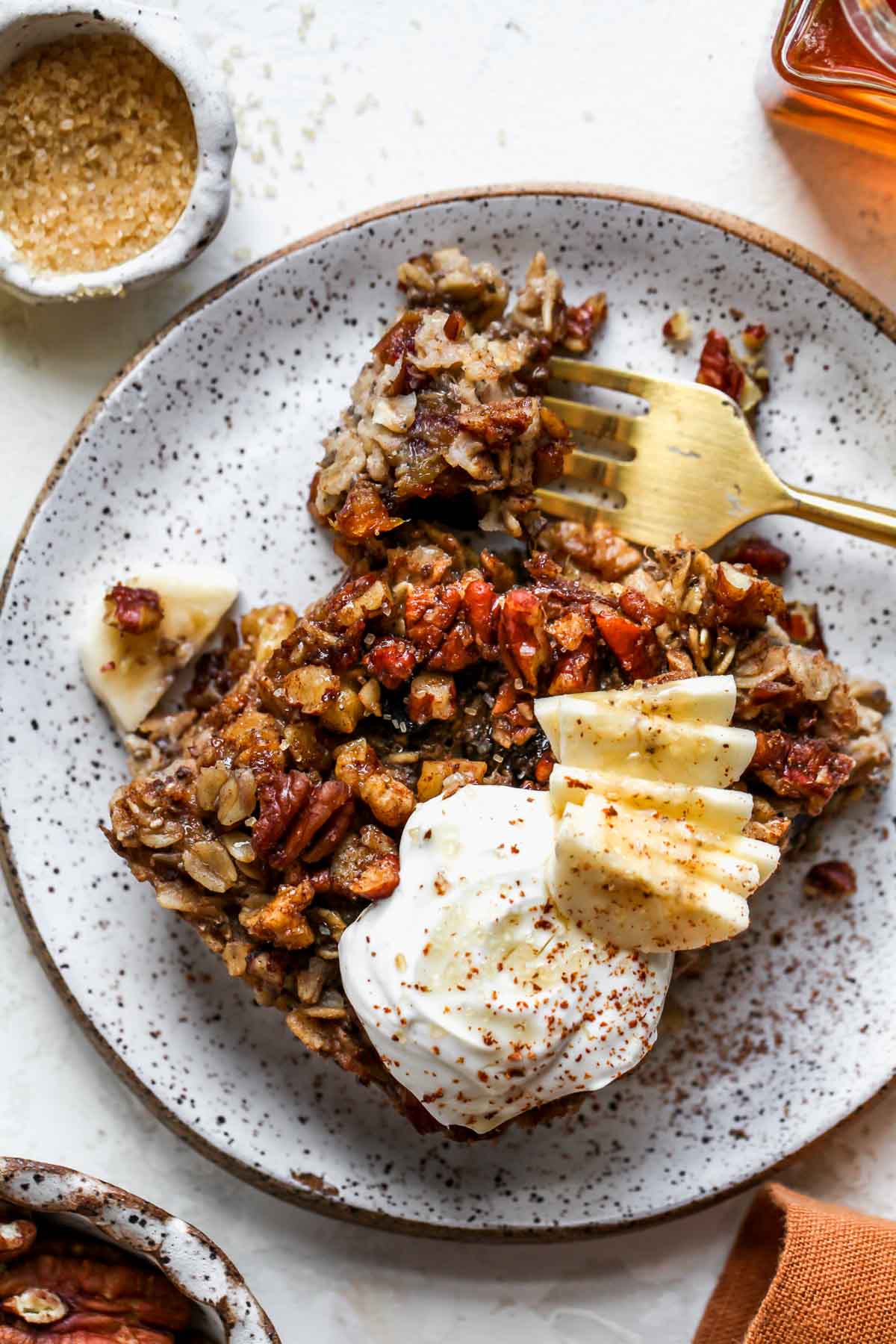 A fork taking a bite of baked oatmeal on a plate