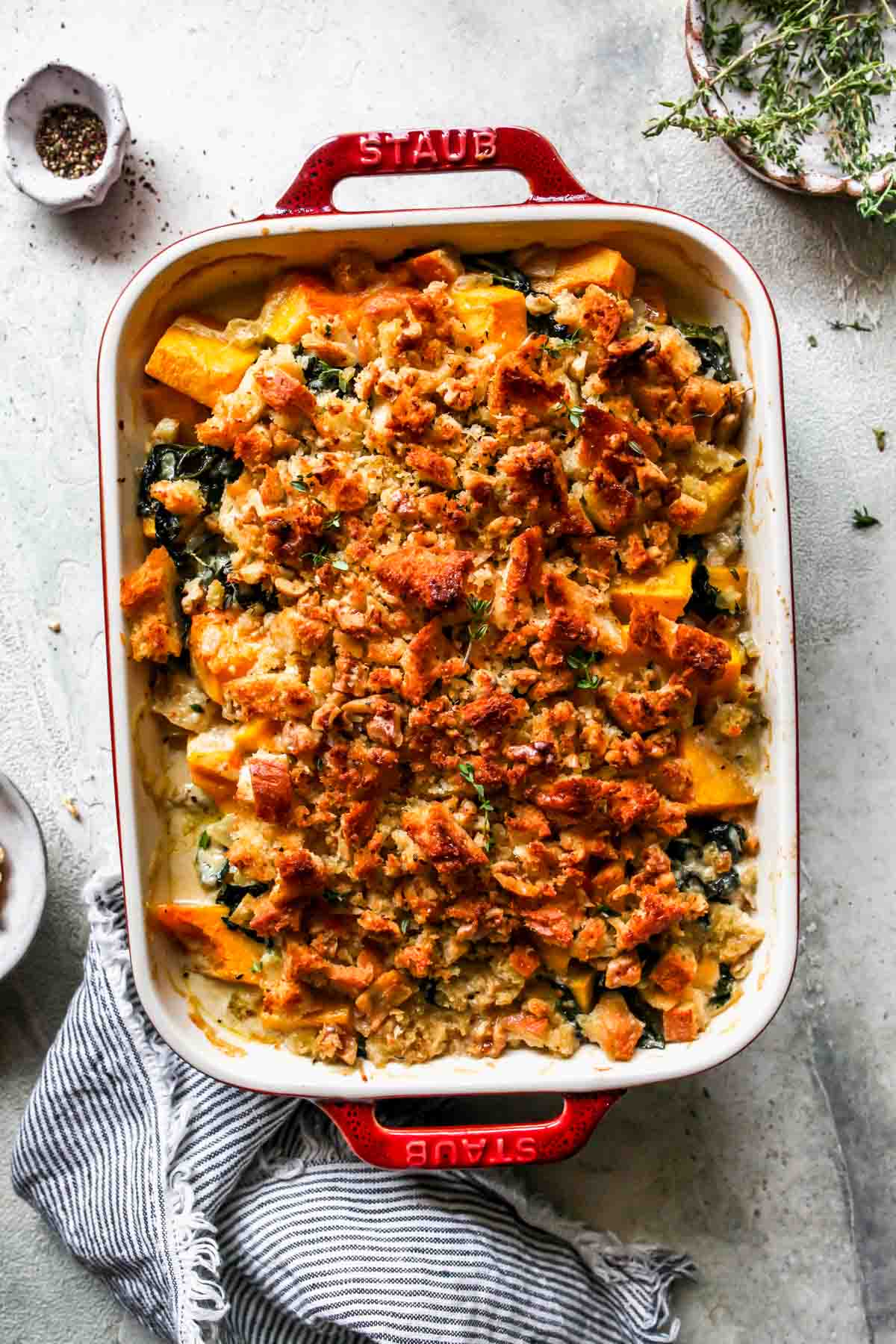 Butternut squash casserole in a red baking dish.