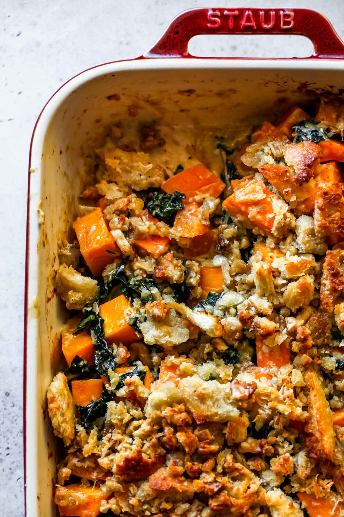 Butternut squash casserole in a pan with a portion scooped out