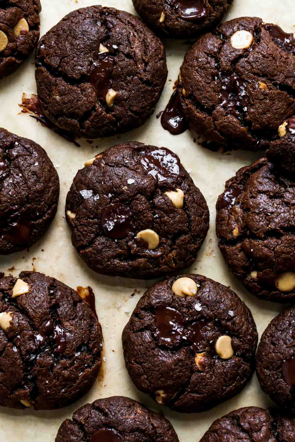 Chocolate peanut butter cookies lined up on a baking sheet
