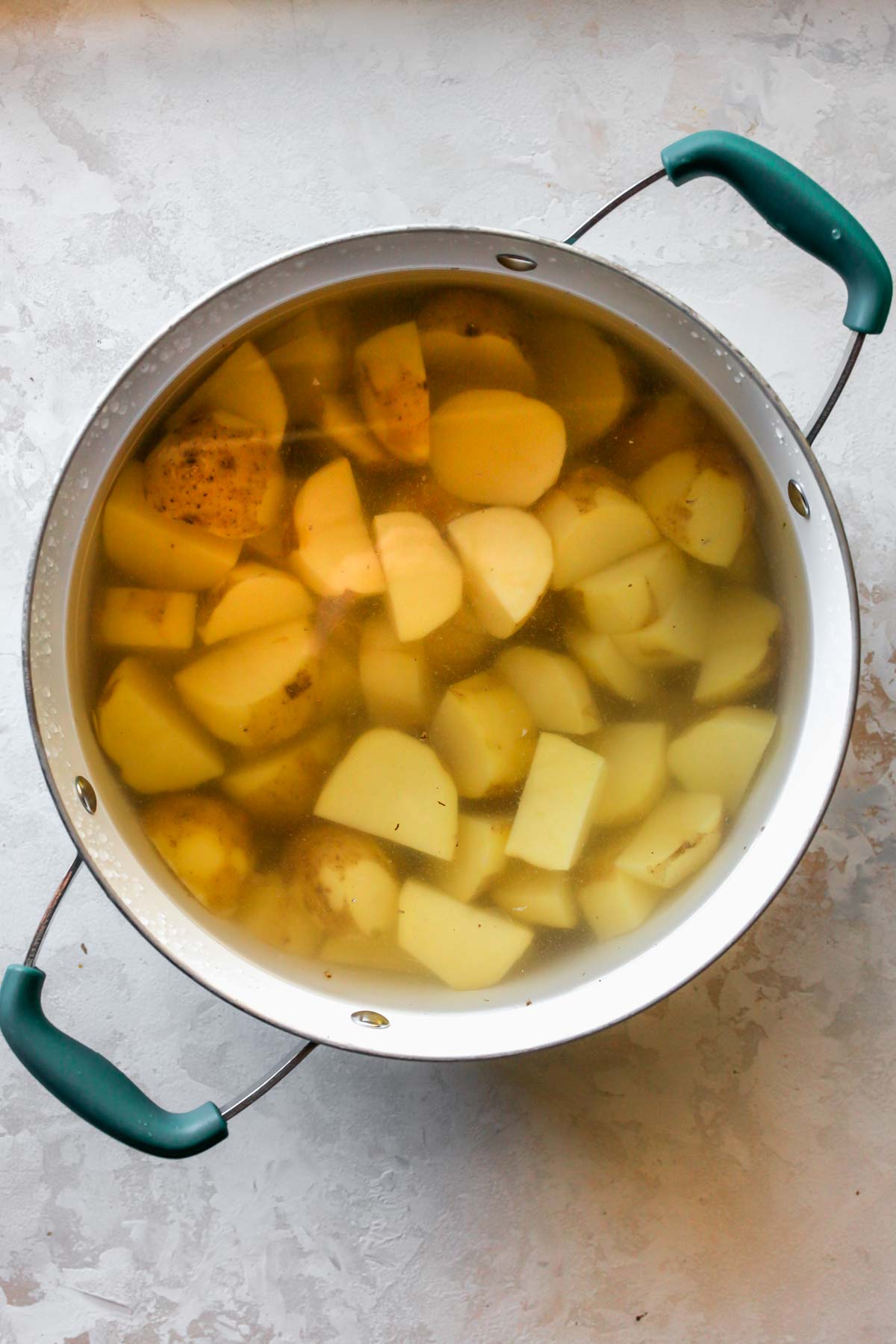 Cut Yukon Gold potatoes in a pot of water
