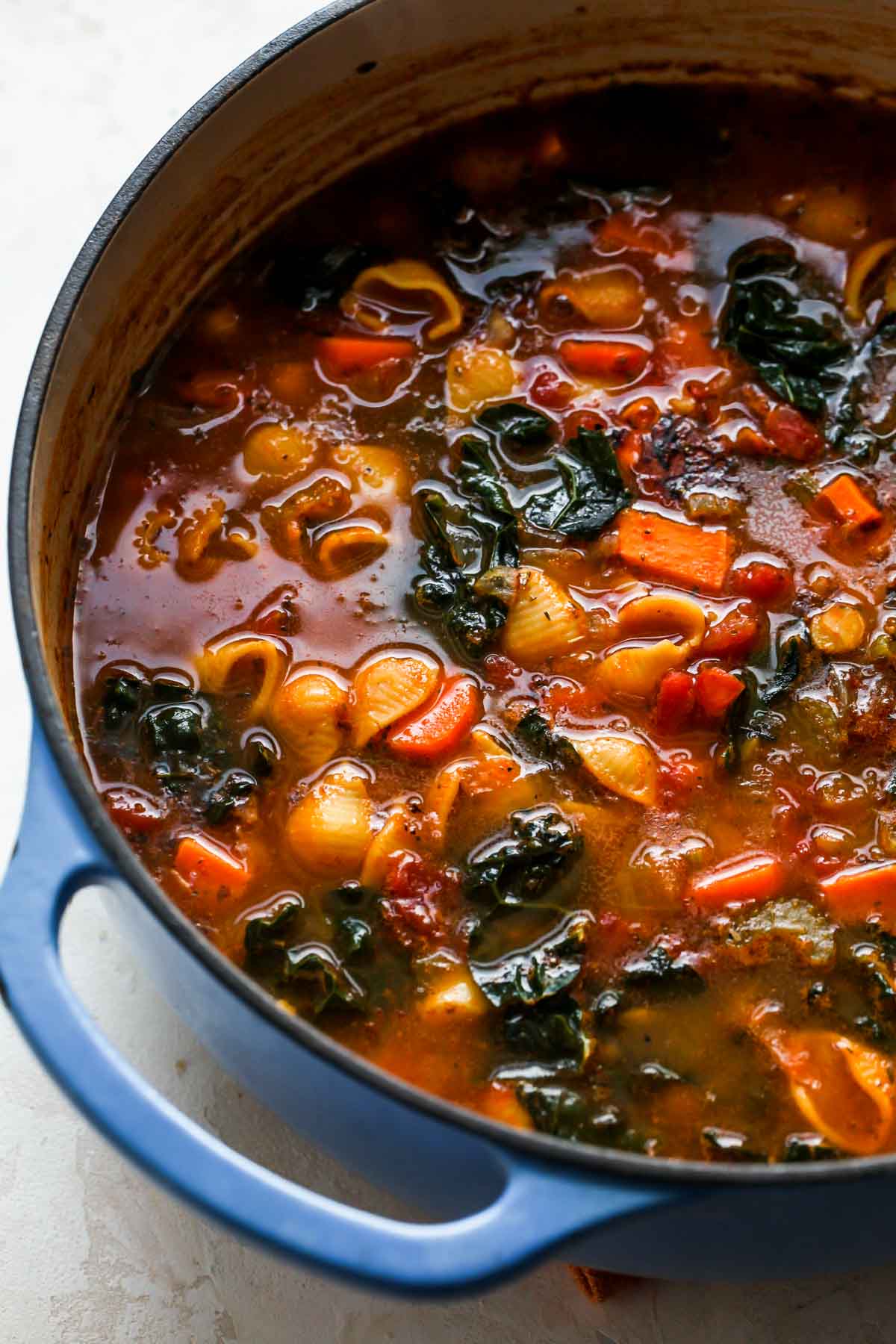 Blue Dutch oven filled with minestrone soup