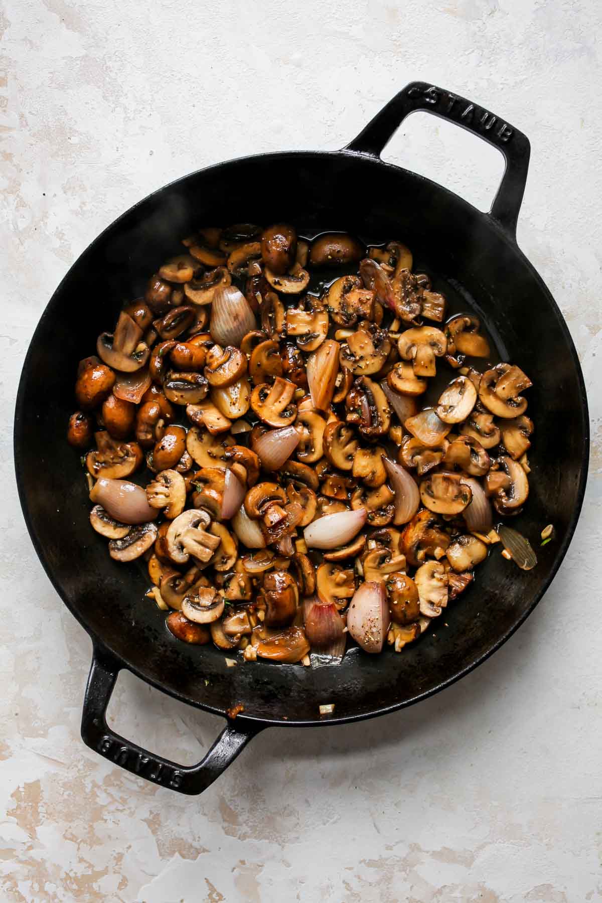 Marsala wine simmering in a skillet of mushrooms