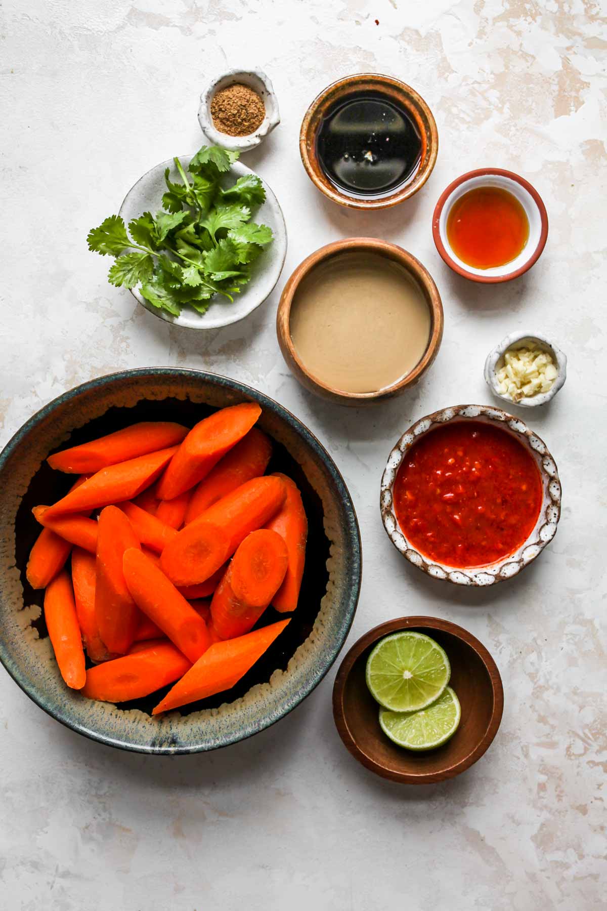 Recipe ingredients on a white board in separate bowls